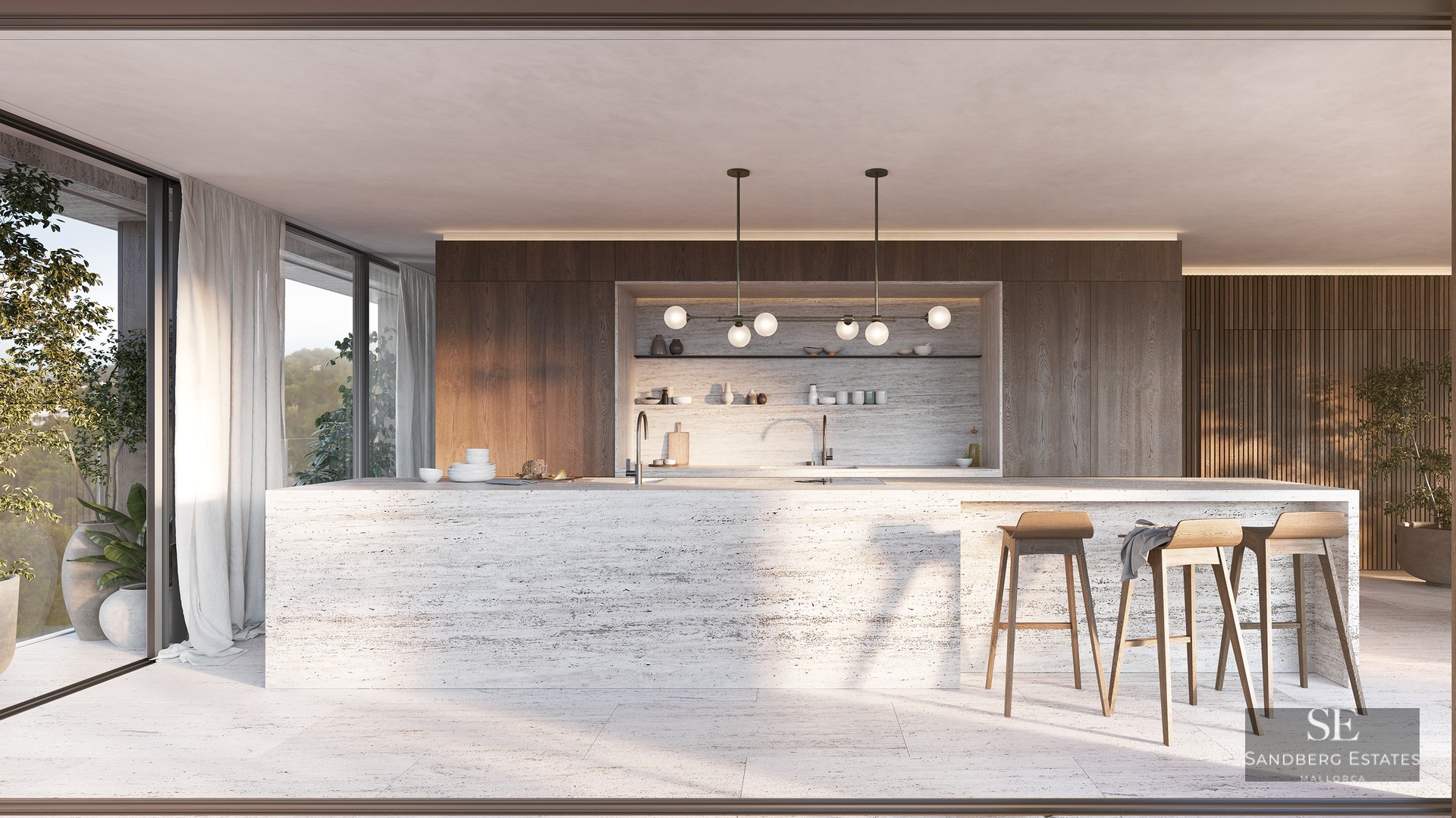 A large travertine kitchen island with wooden stools in a modern open-plan space with floor-to-ceiling windows.