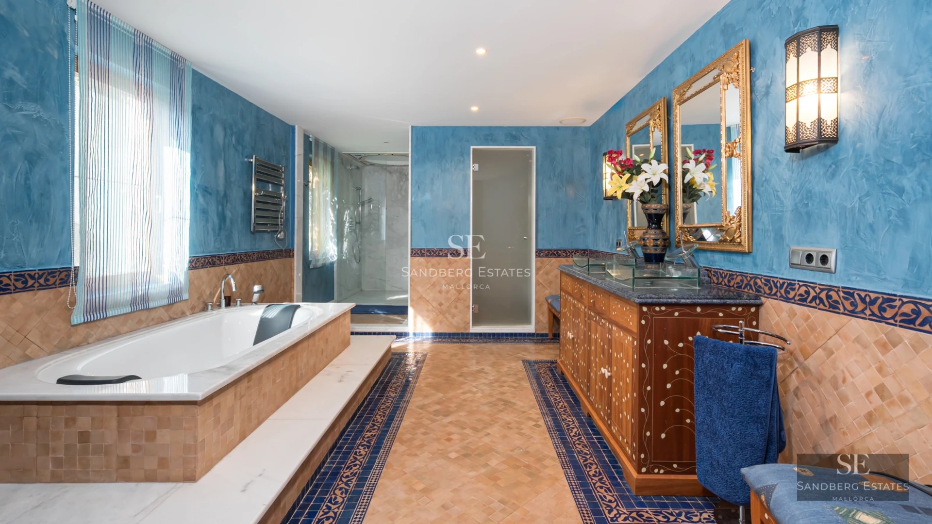 View of infinity pool with lush garden and modern architecture. Large windows reflect natural light. Peaceful and elegant landscape.