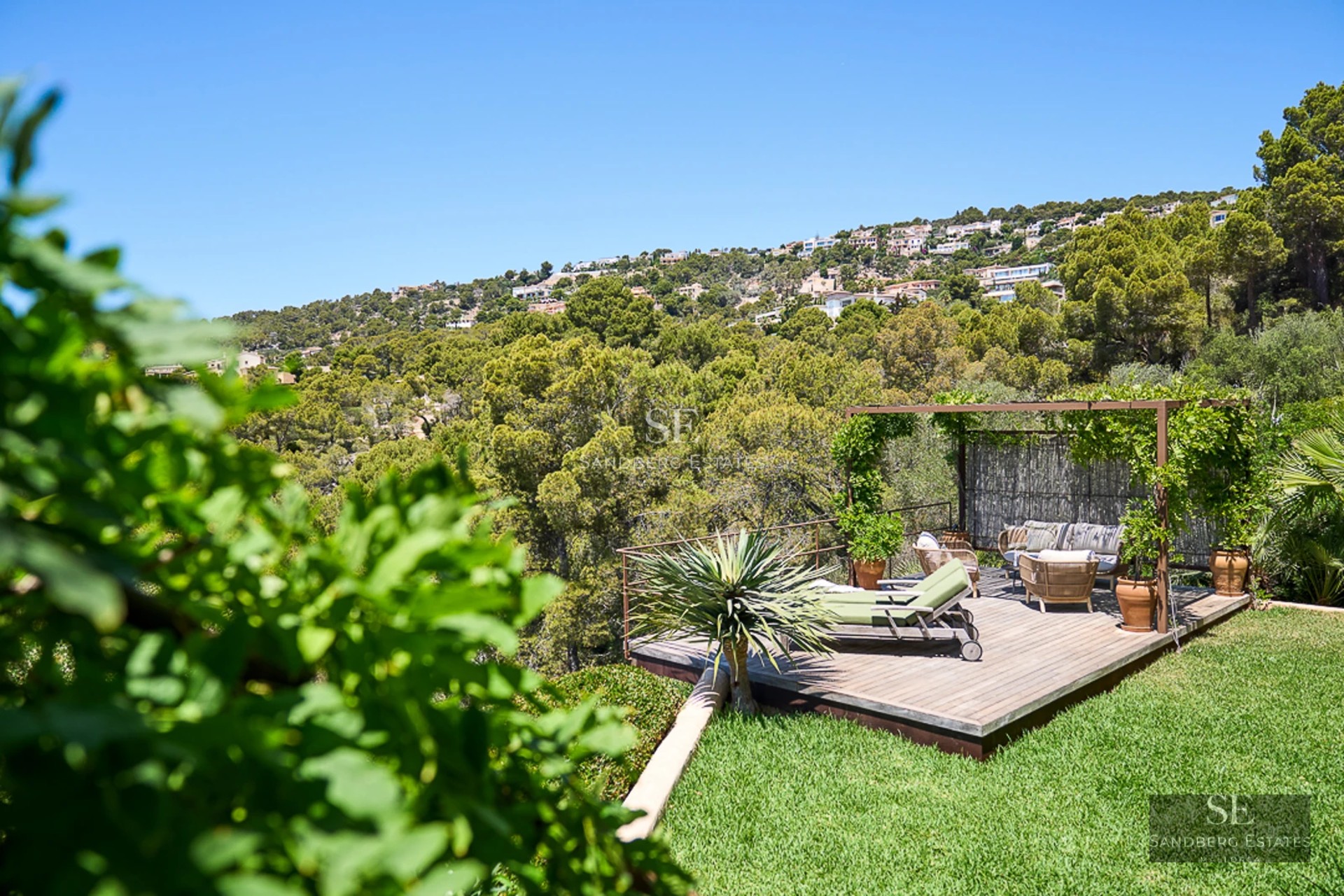 Modern penthouse featuring a spacious terrace and views. Elegant furniture, wood floors, warm lighting, and minimalist design.