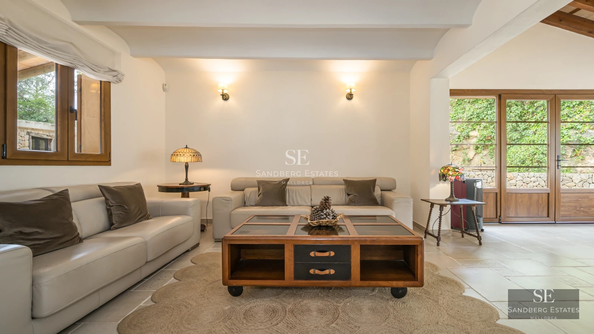 Spacious living room with large windows, modern fireplace, and designer furniture. Panoramic views and abundant natural light.