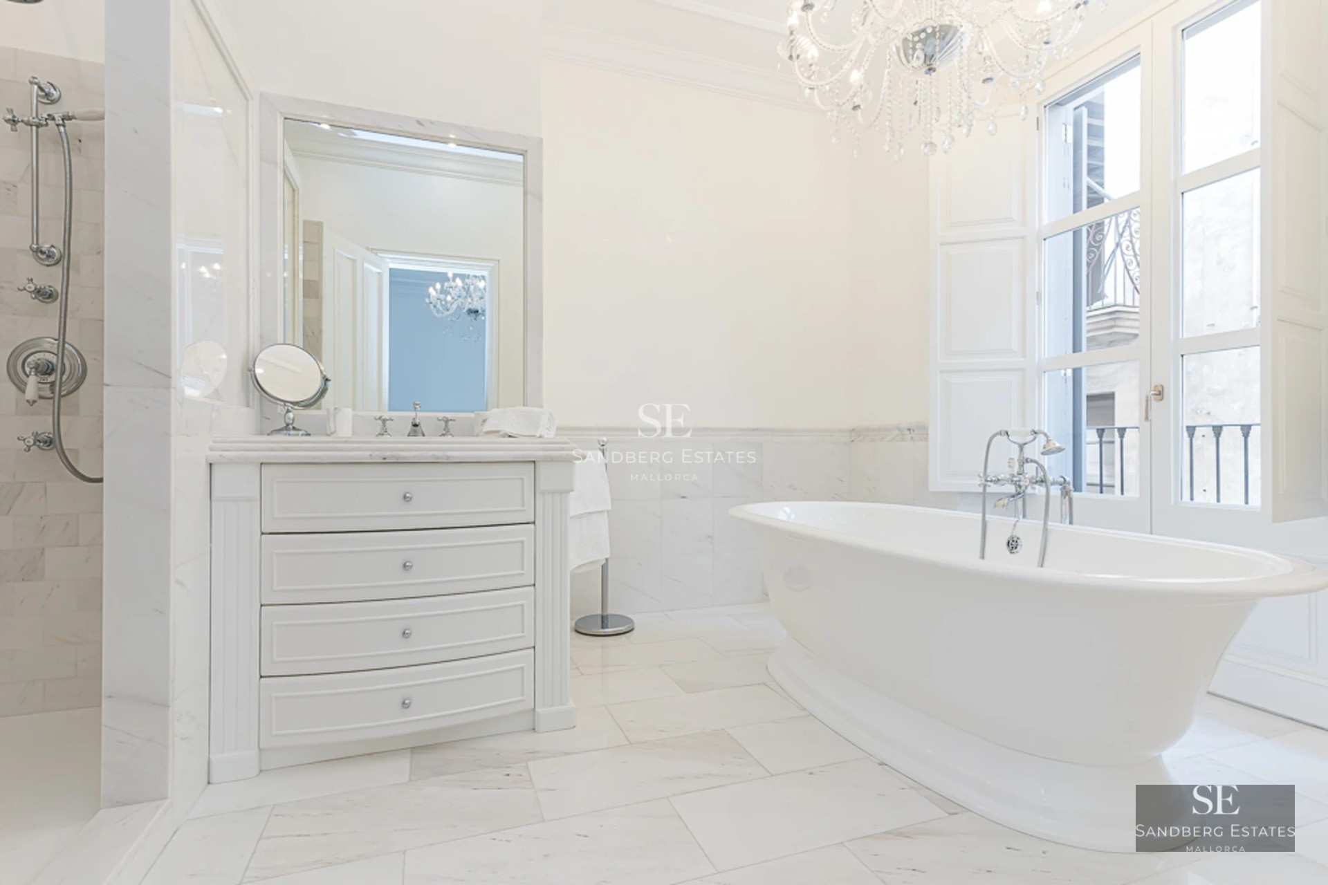 View of infinity pool with glass edge and lush garden. Modern architecture with clean lines and manicured landscaping.