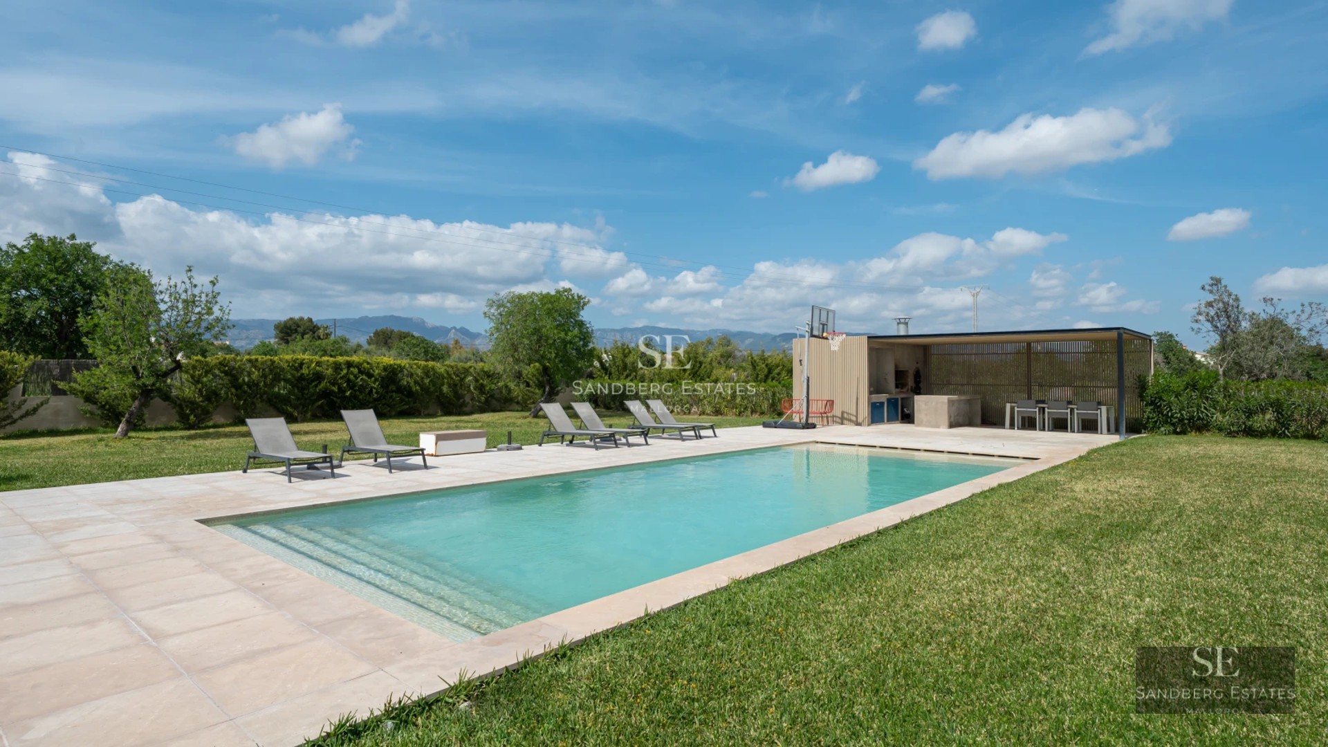 Aerial view of a modern villa featuring a pool, lush garden, and minimalist architecture. Elegant design and luxury finishes.