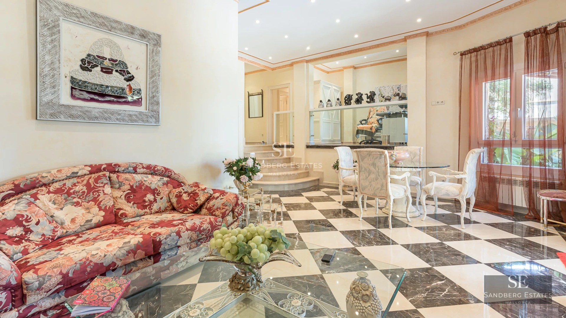 Bright living room with large windows, modern sofas, and minimalist decor. Panoramic views and access to the terrace.