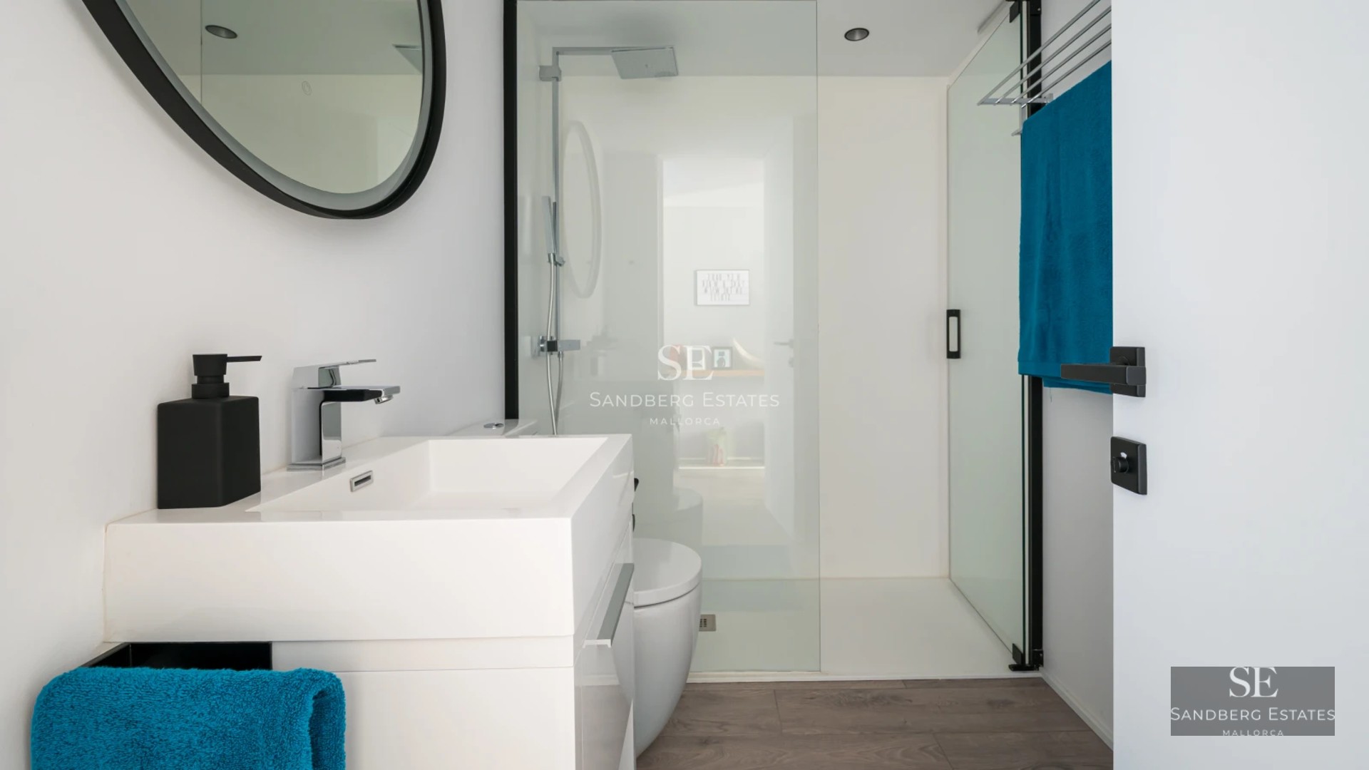 Exterior of a modern villa featuring a pool, manicured garden, and expansive windows offering stunning views.