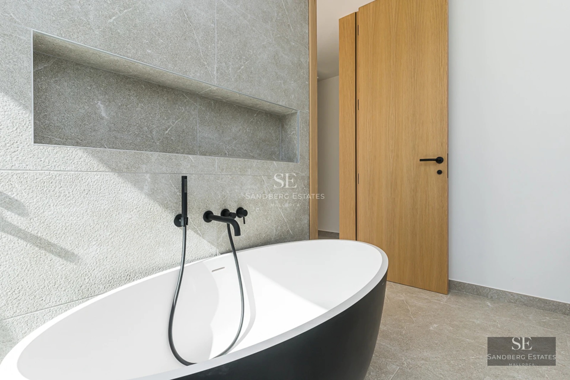 Vaste terrasse avec piscine à débordement et vue panoramique sur la mer. Design moderne avec plancher en bois et mobilier élégant.