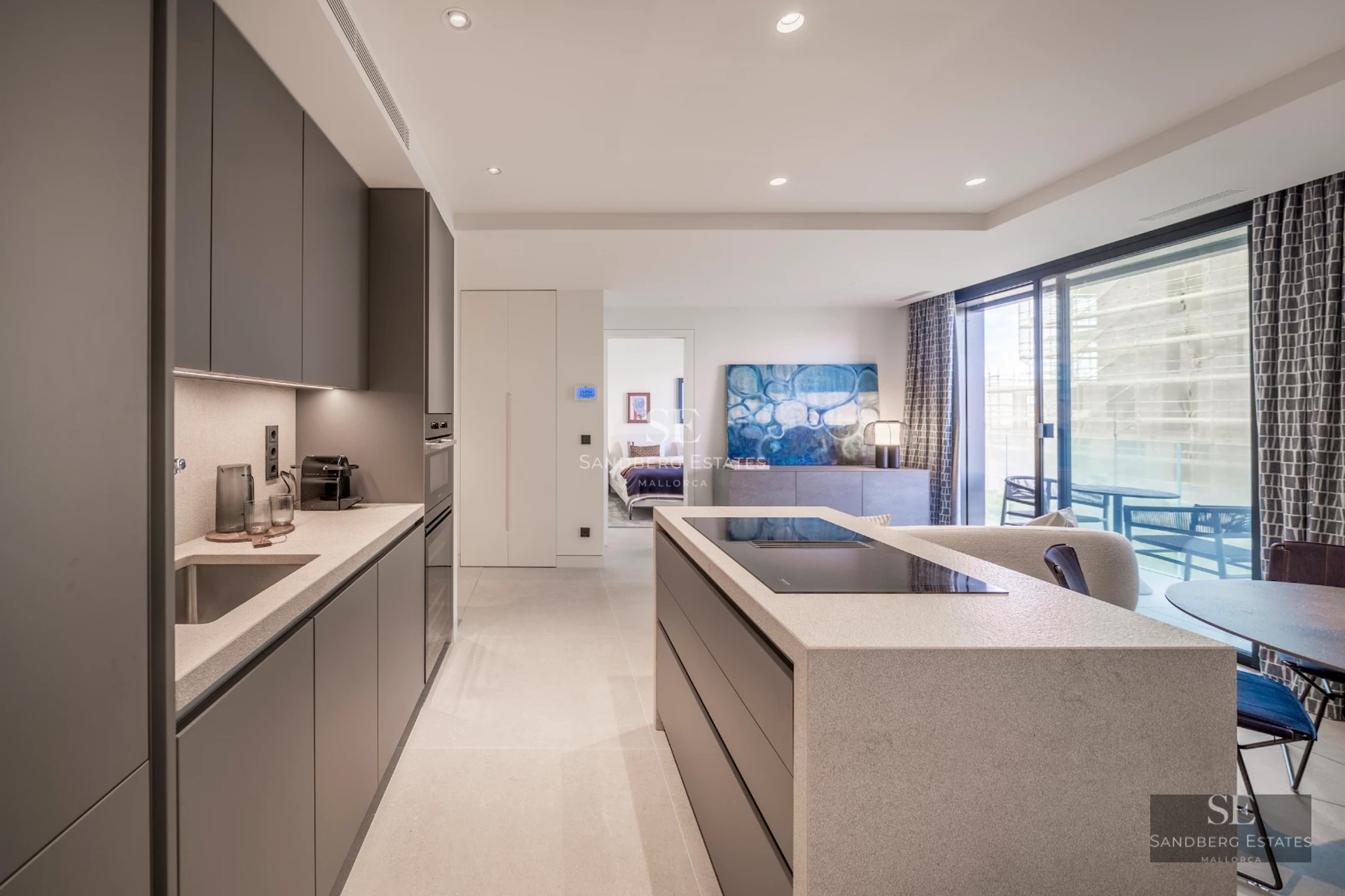 Spacious balcony with sea view. Modern design with wooden floor, glass railing, and stylish furniture. Abundant natural light.