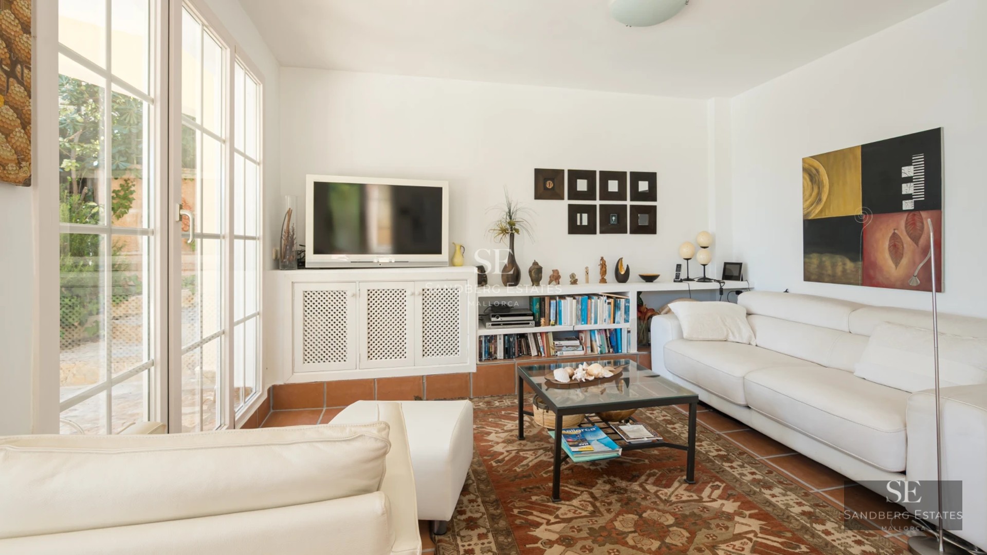 Spacious living room with floor-to-ceiling windows overlooking the pool. Leather sofa, modern fireplace, wood floors. Natural lighting, contemporary design.
