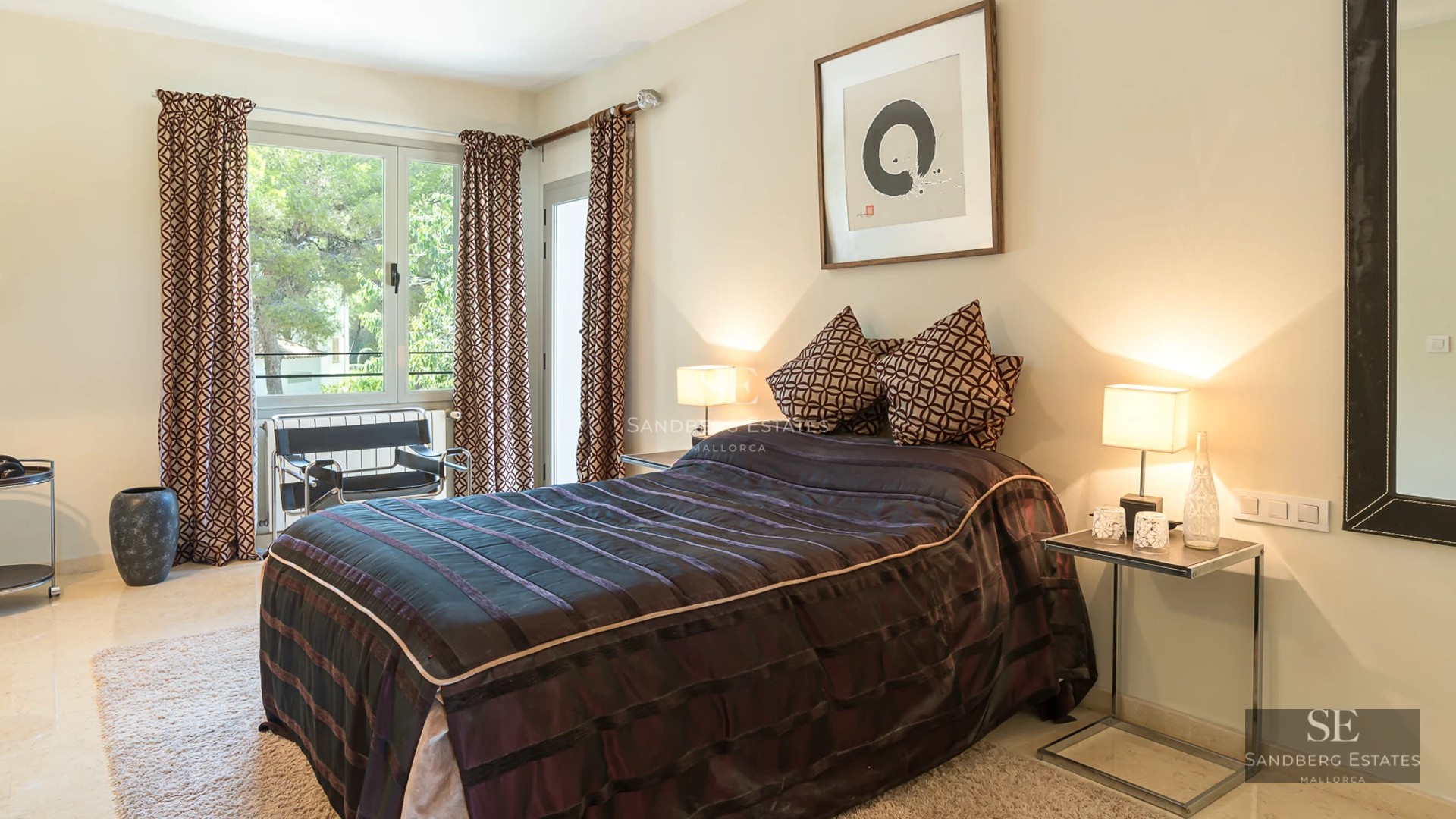 Spacious living room featuring panoramic windows, designer sofa, and fireplace. Elegant decor, terrace access with views. Design lighting.