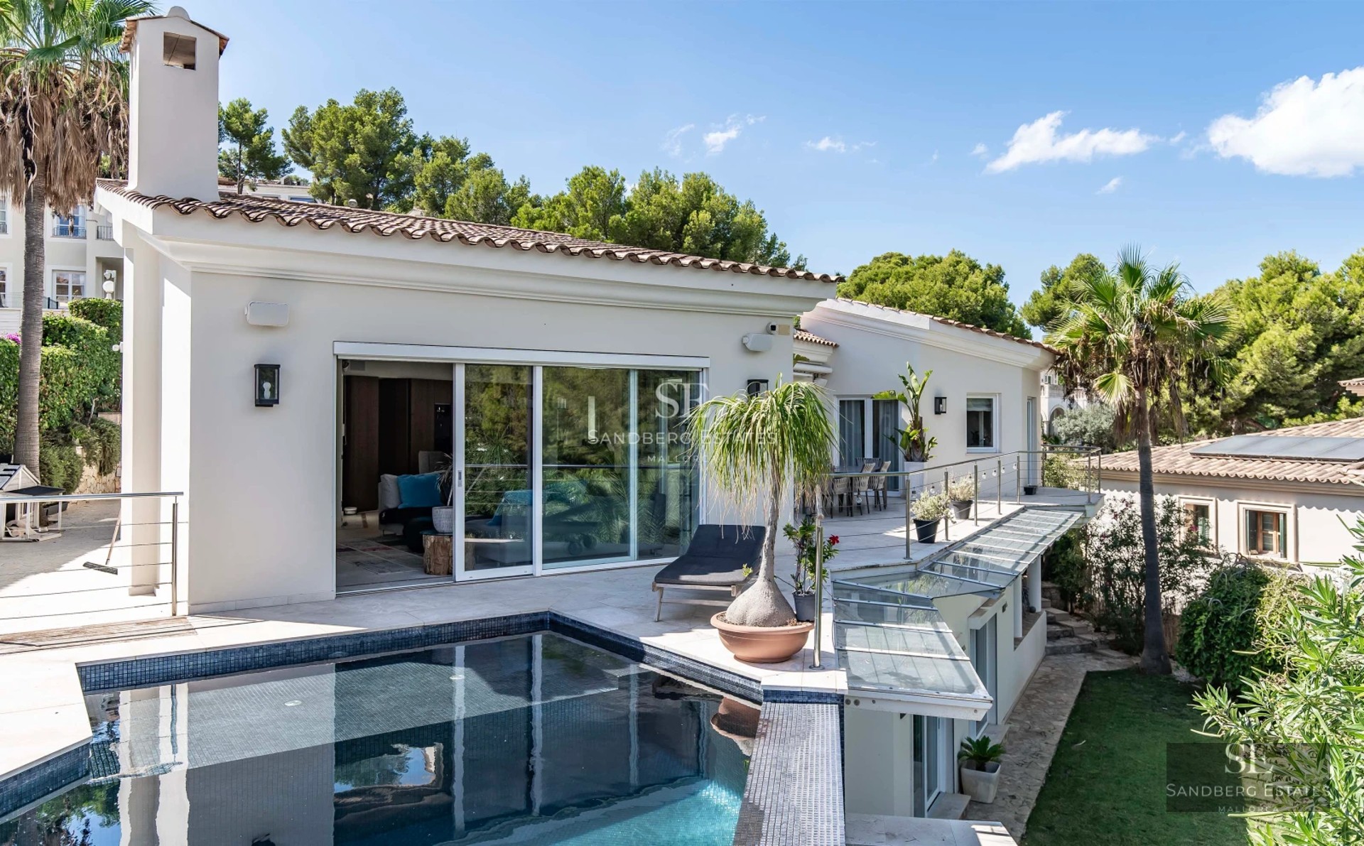 Exterior view of a modern villa with a pool. Minimalist architecture, large windows, reflective pool, lush garden. Ambient lighting.