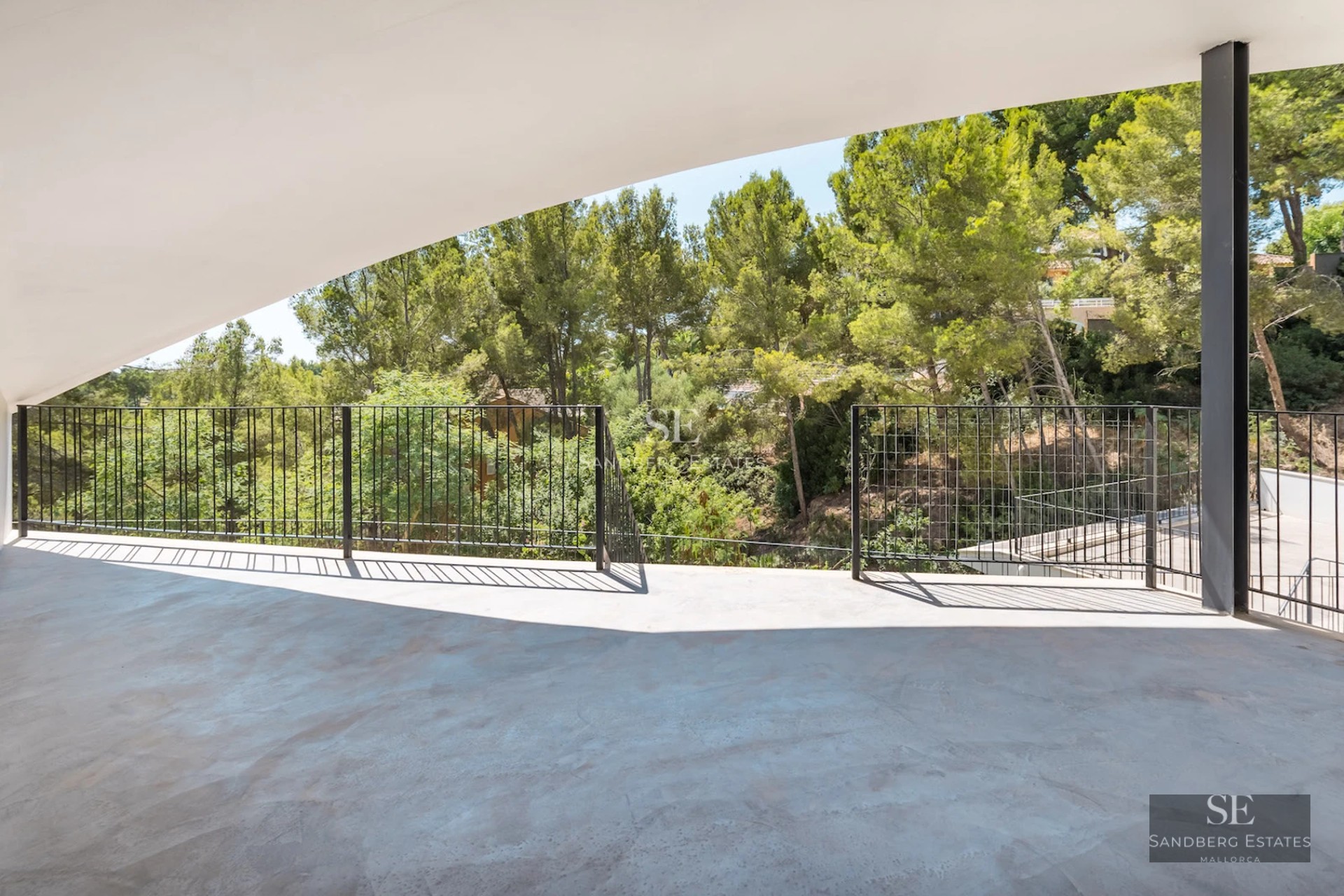 Spacious living room with large windows, infinity pool, and panoramic views. Modern design, natural lighting, and high-quality materials.