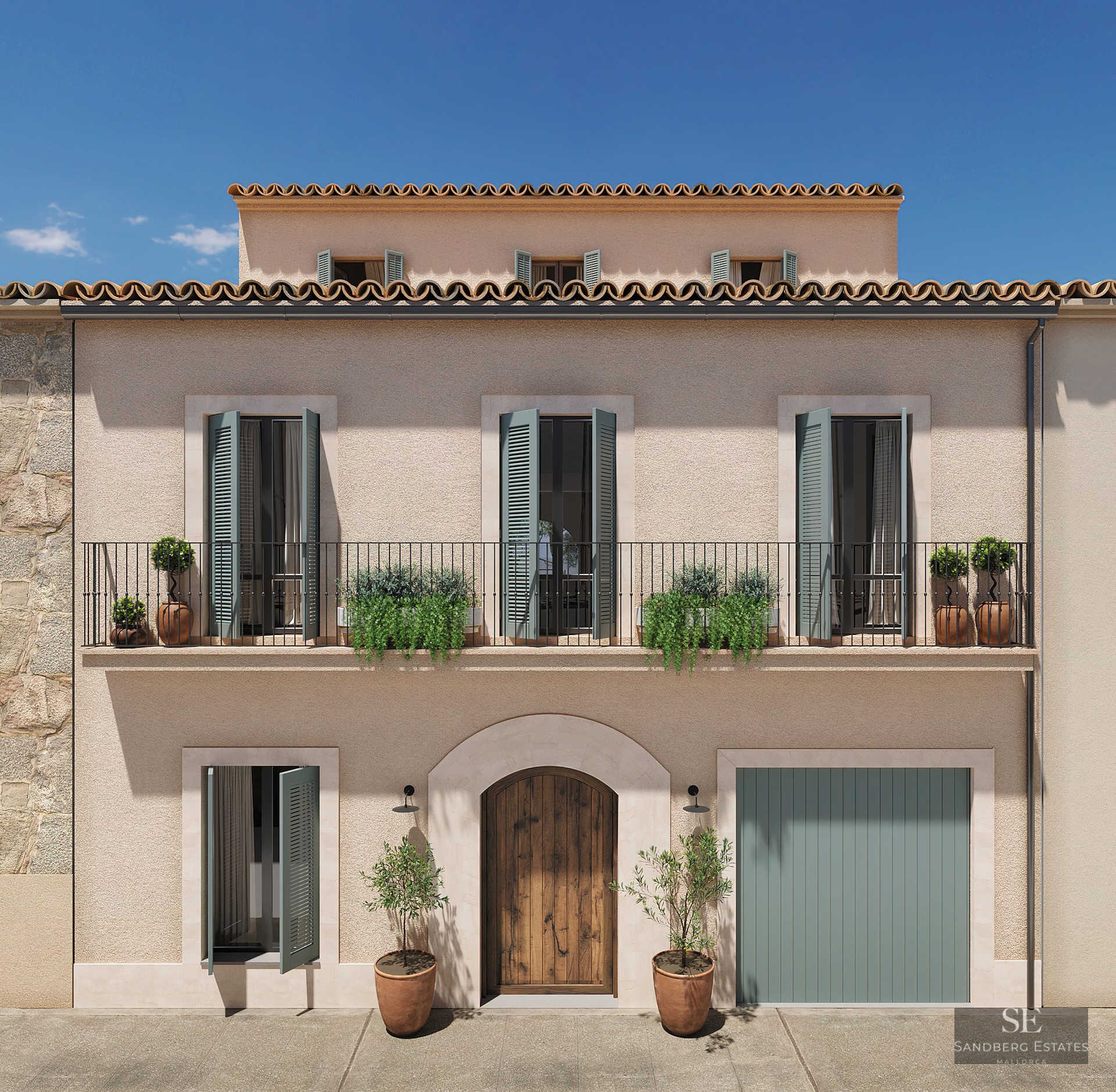 Three-story facade with beige stucco walls, sage green shutters, wrought iron balcony, and arched wooden door.