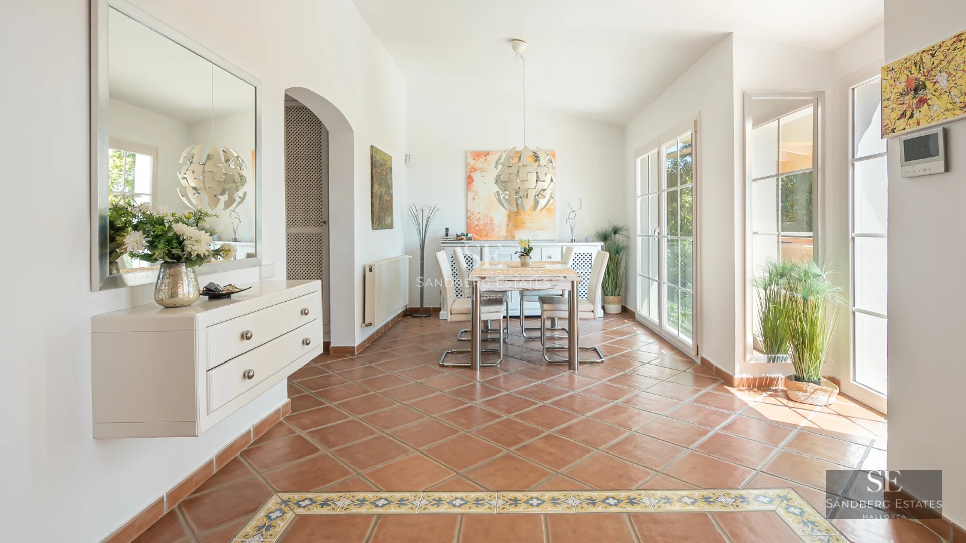 Spacious living room with floor-to-ceiling windows, designer sofas, fireplace, and garden view. Modern elegance in every detail.
