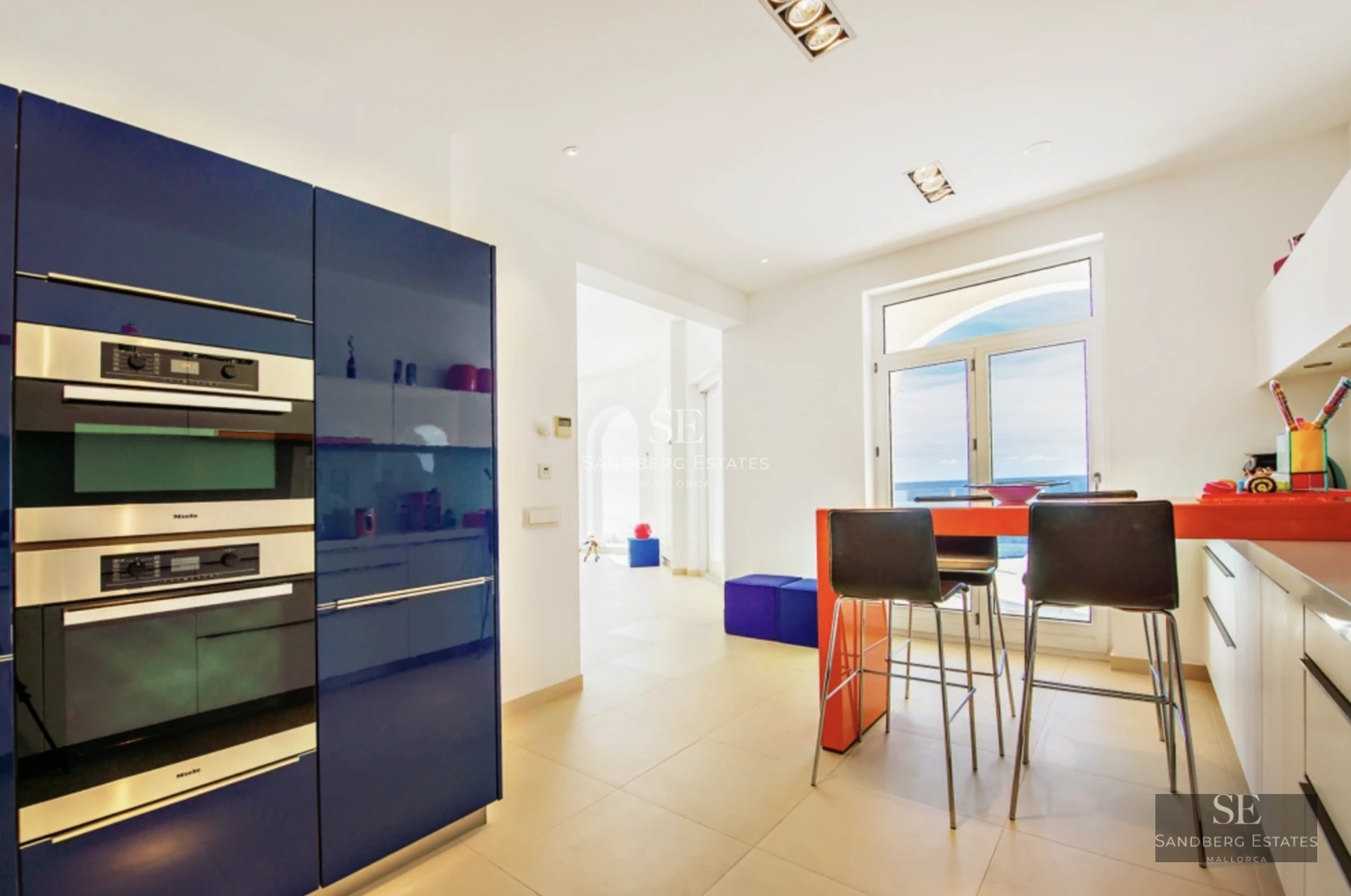 Exterior of a modern villa featuring a reflecting pool, large windows, and lush landscaping. Warm lighting.