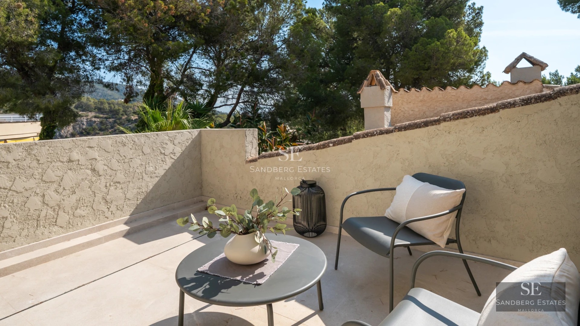 Spacious, bright living room with outdoor pool visible through large windows. Modern design, wooden floors, and minimalist furniture.
