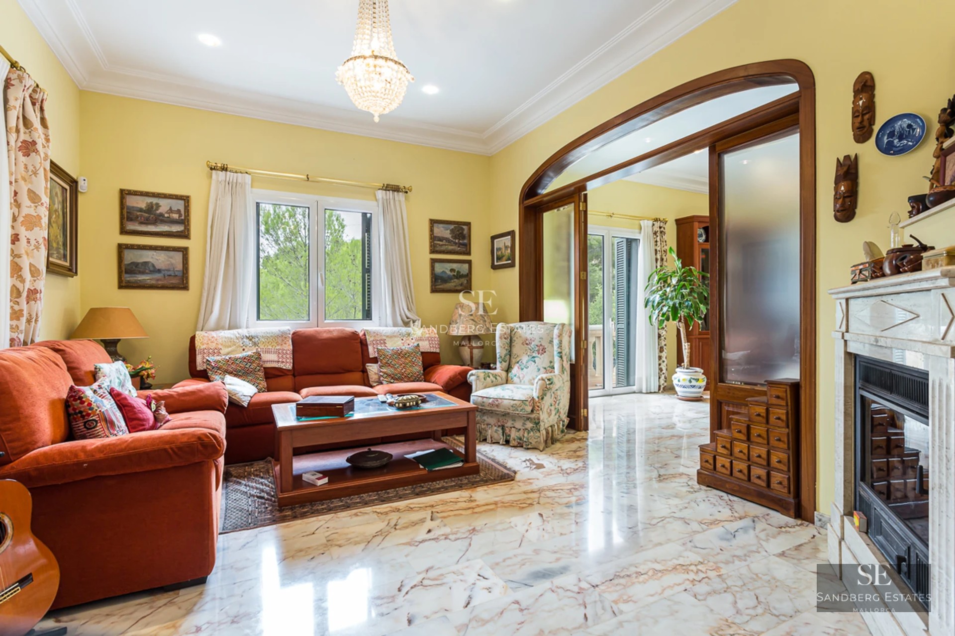 Spacious balcony with panoramic sea view. Glass railing, light wood flooring and modern outdoor furniture.