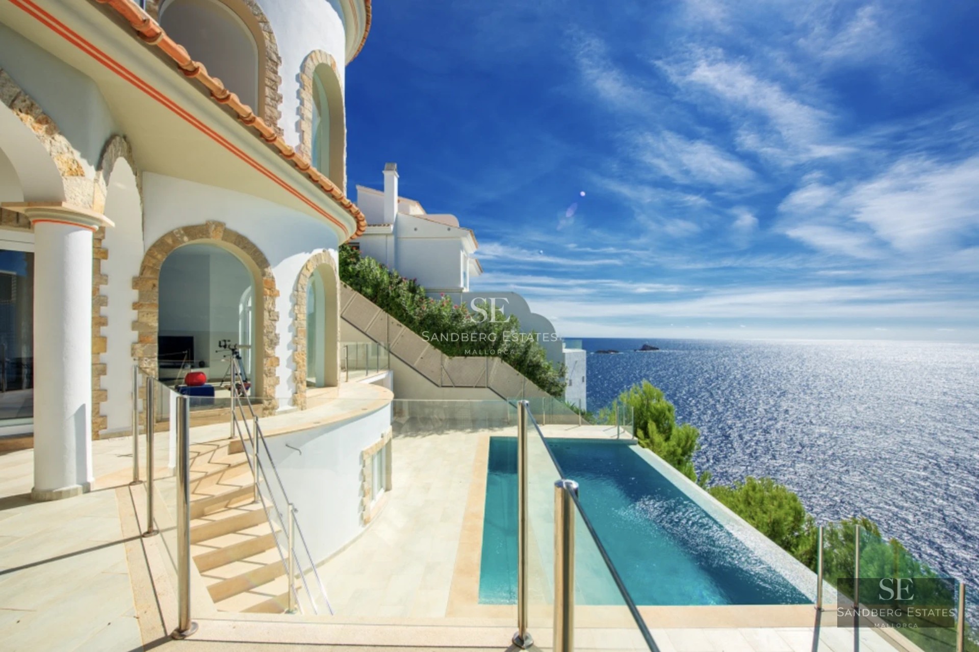 Exterior view of a modern house featuring a swimming pool, gardens, and large windows providing natural light. Minimalist architecture.