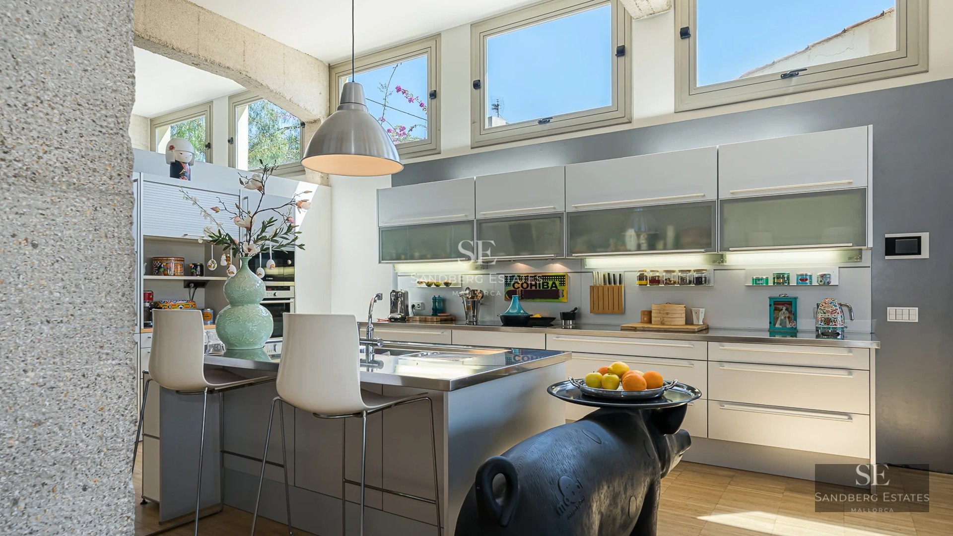 Exterior view of a modern villa with a pool, surrounded by greenery. Minimalist architecture with large windows.