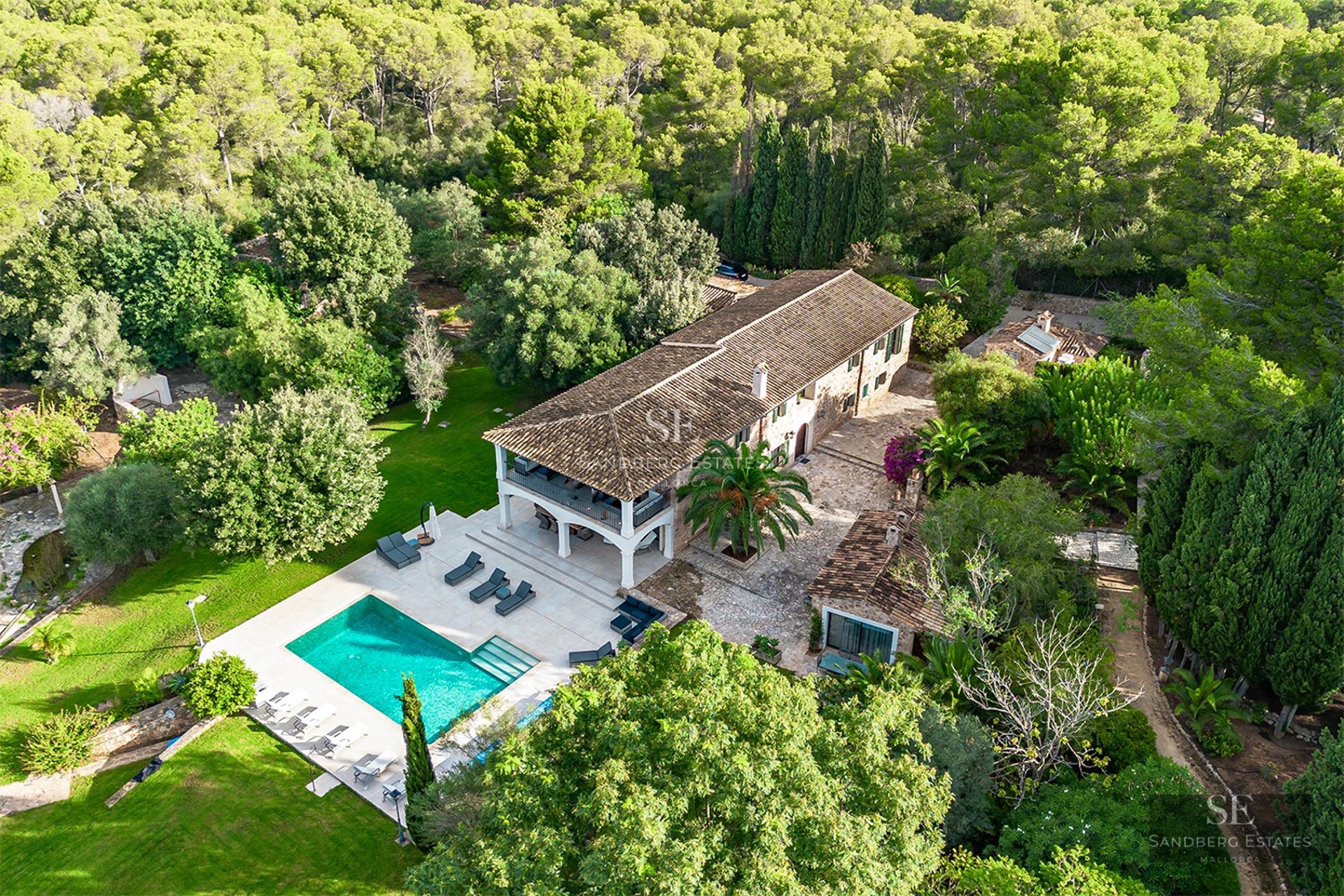 Spacious terrace with pool, sun loungers, and panoramic views. Modern design with glass railings and light-colored flooring.