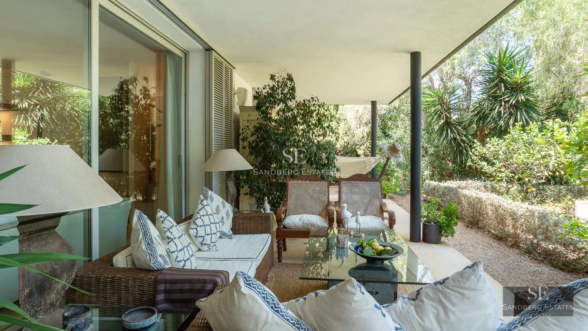 Bright interior with balcony and sea view. Modern furniture, wooden floors and large windows.