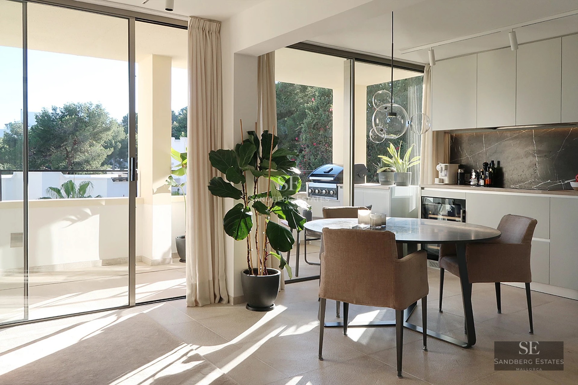 Aerial view of a modern villa with a pool, lush garden, and minimalist architecture. White facade with large windows.