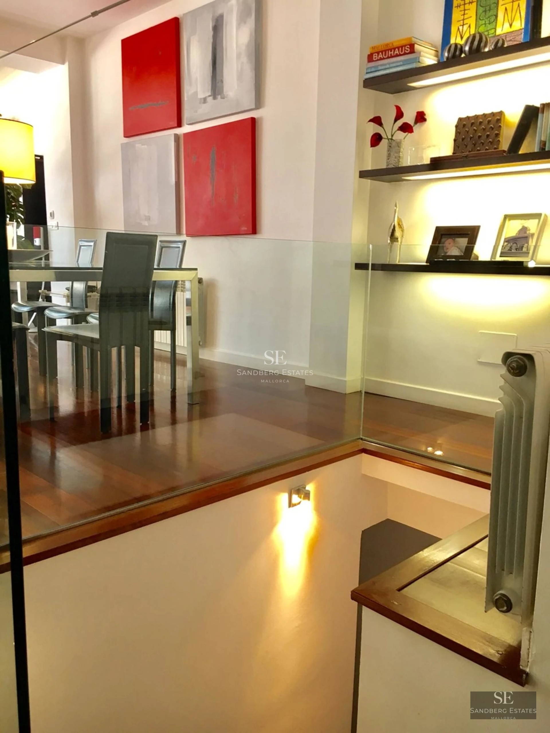 Exterior view of a modern villa featuring a swimming pool, sun loungers, and lush garden. Contemporary architectural design.