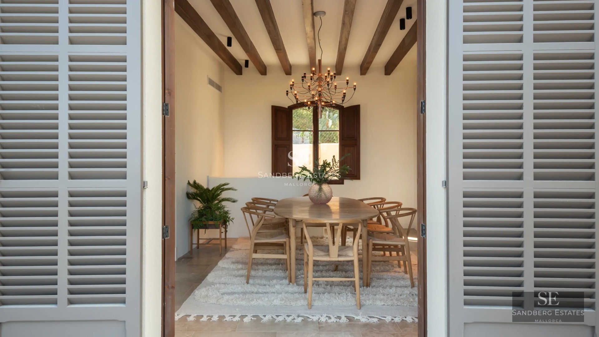 Pool view with modern design, stone edge, lounge chairs, and lush greenery. Natural lighting and blue skies.