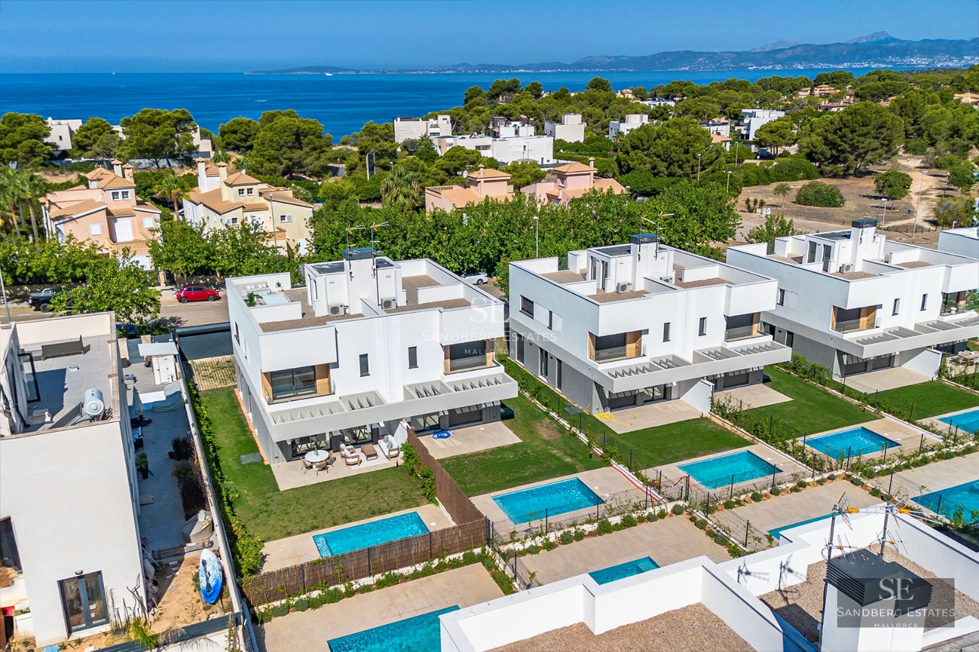 Exterior view of a modern villa with infinity pool, large windows, and lush landscaping. Sleek and contemporary design.