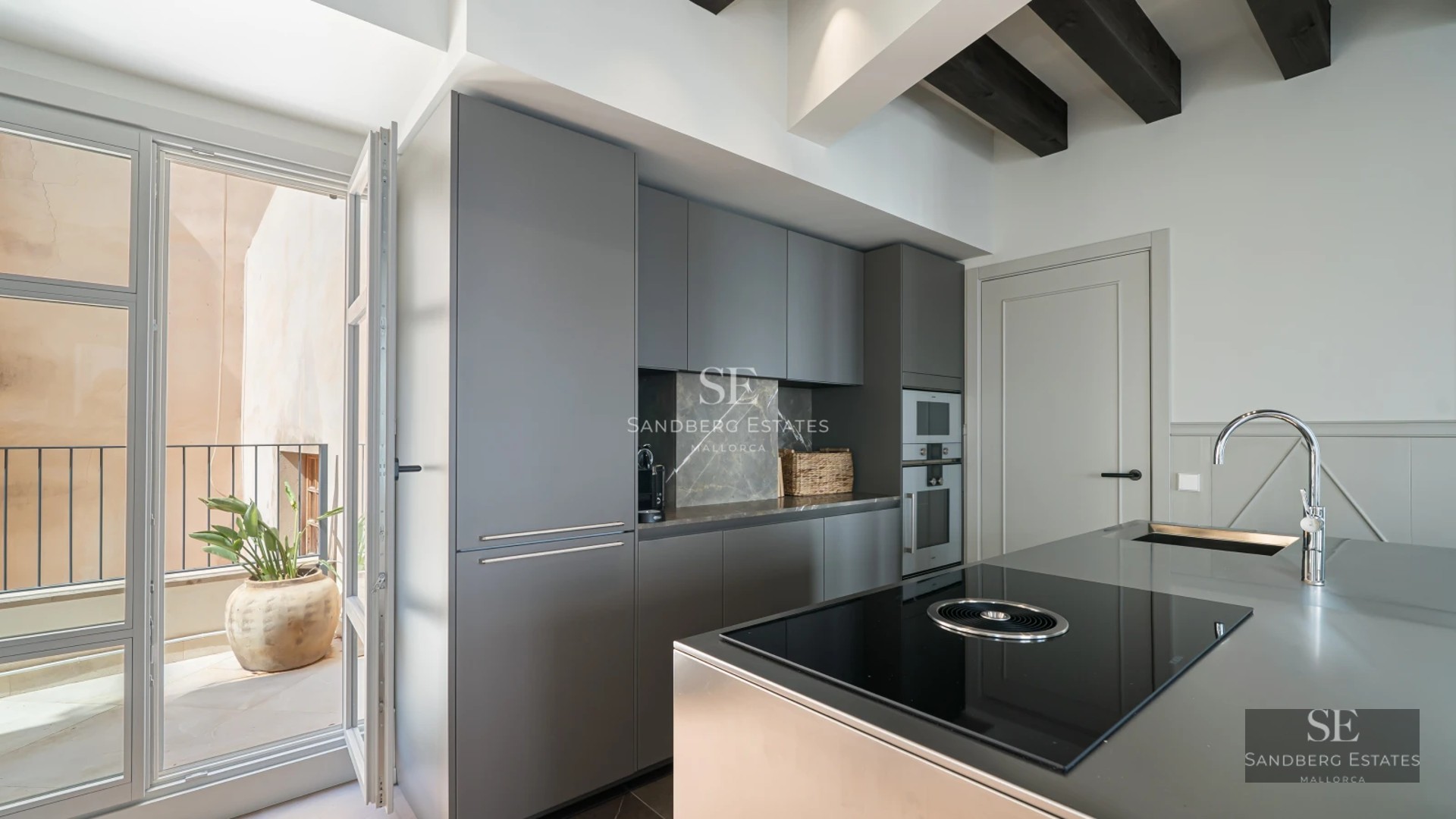 Exterior view of a modern villa with an infinity pool, large terraces, and minimalist design. Lush vegetation surrounds the property.