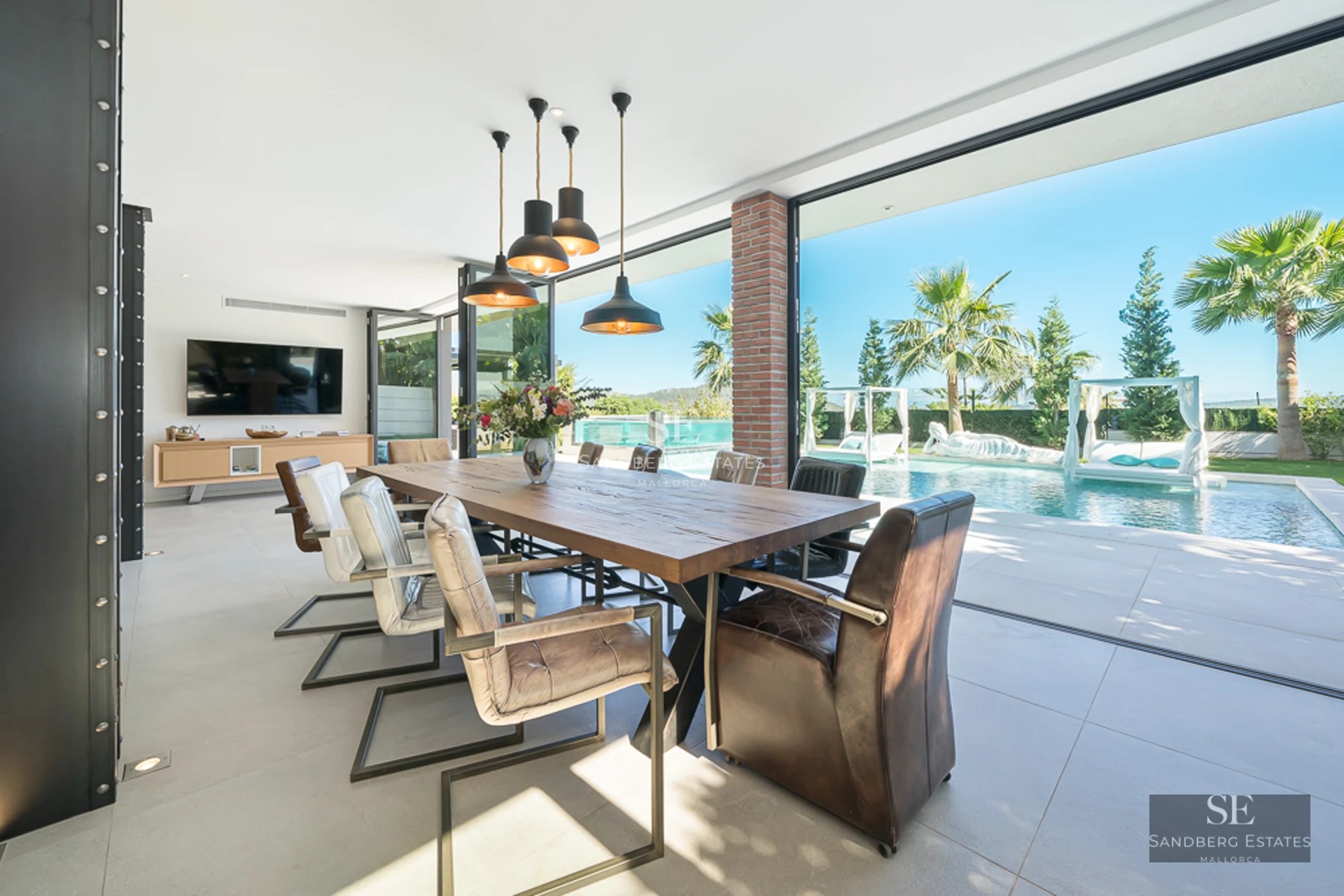 Exterior view of modern villa with reflective pool, lush garden, and minimalist architectural design.