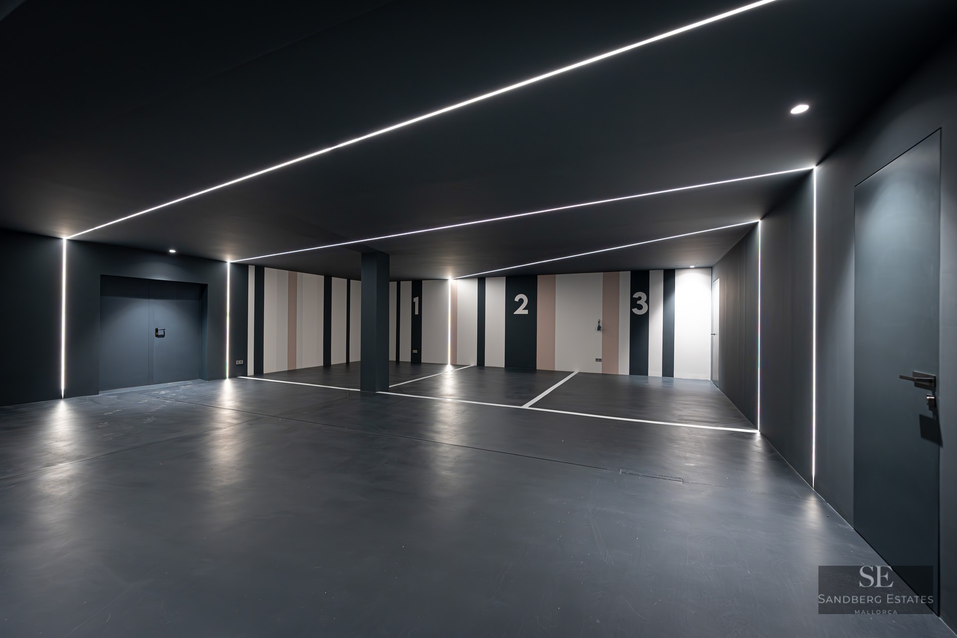 Luxury indoor parking with charcoal walls, numbered spaces 1-3, and linear LED strip lighting on ceiling and walls.