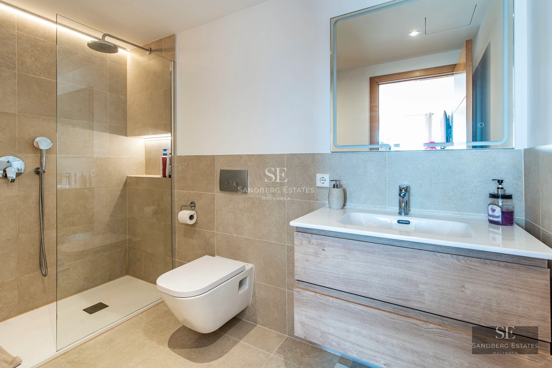 Spacious living room with panoramic windows, light wood flooring, modern fireplace, and designer furniture. Exceptional natural light.