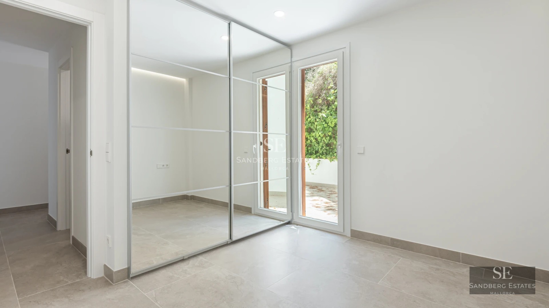 Spacious terrace with sea view, modern furniture, wooden floors, glass railing. Contemporary design.