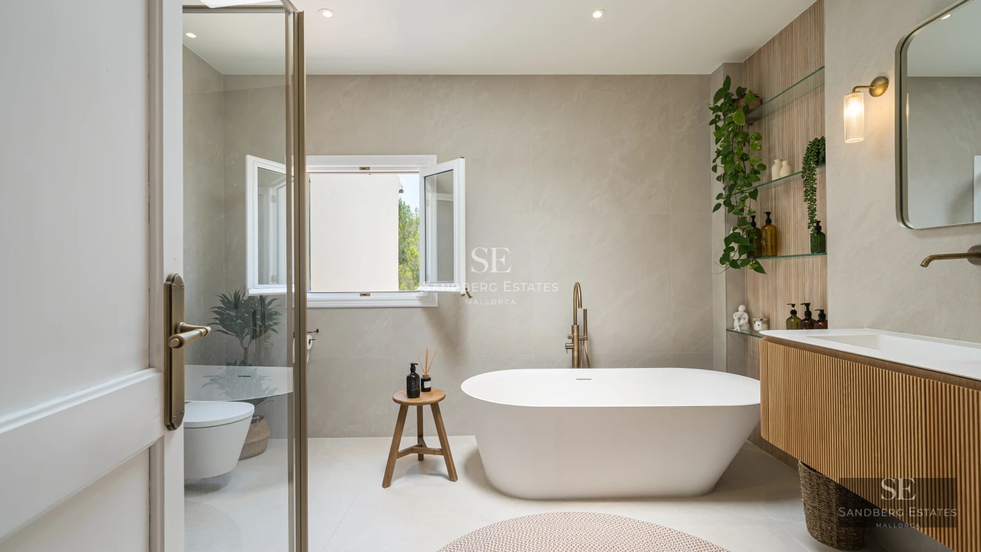 Spacious balcony with sea view. Modern outdoor sofa, wooden floor, glass railing, clear blue sky. Bright and spacious.