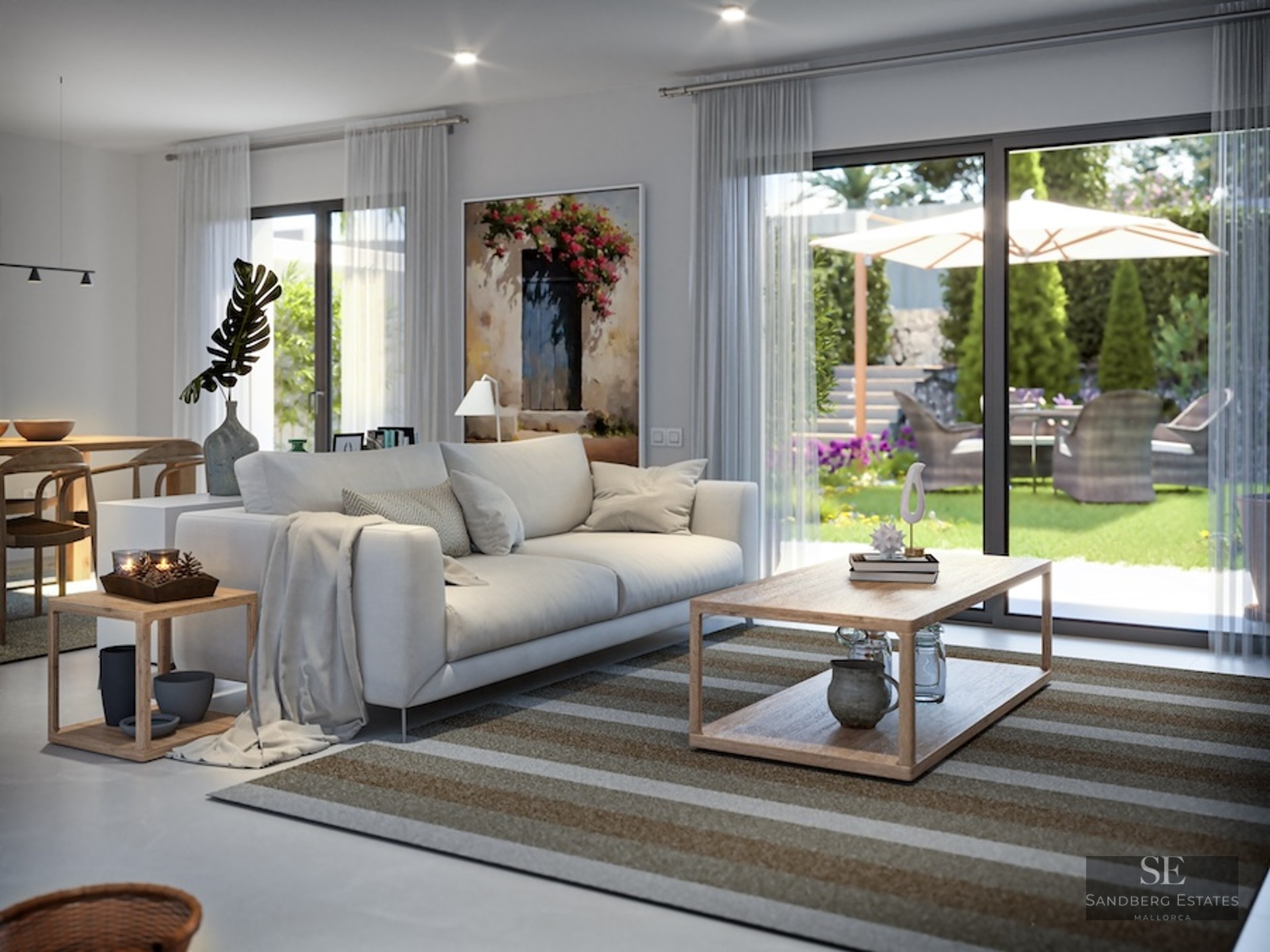 Contemporary living room featuring a white sofa and large sliding glass doors opening to a lush sunlit garden.