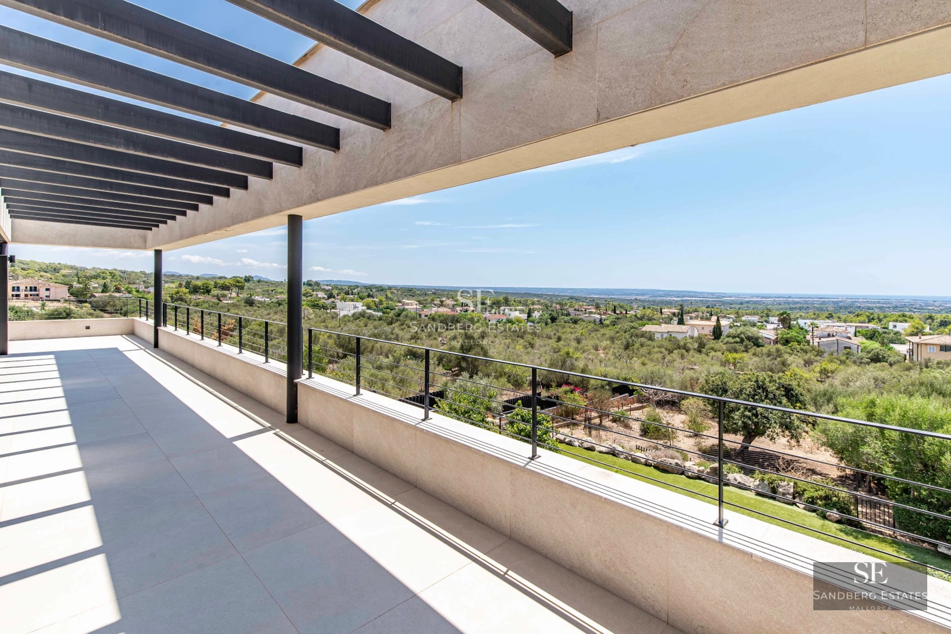 Spacious terrace with infinity pool, sun loungers, and ocean view. Sleek, modern design with high-end finishes.