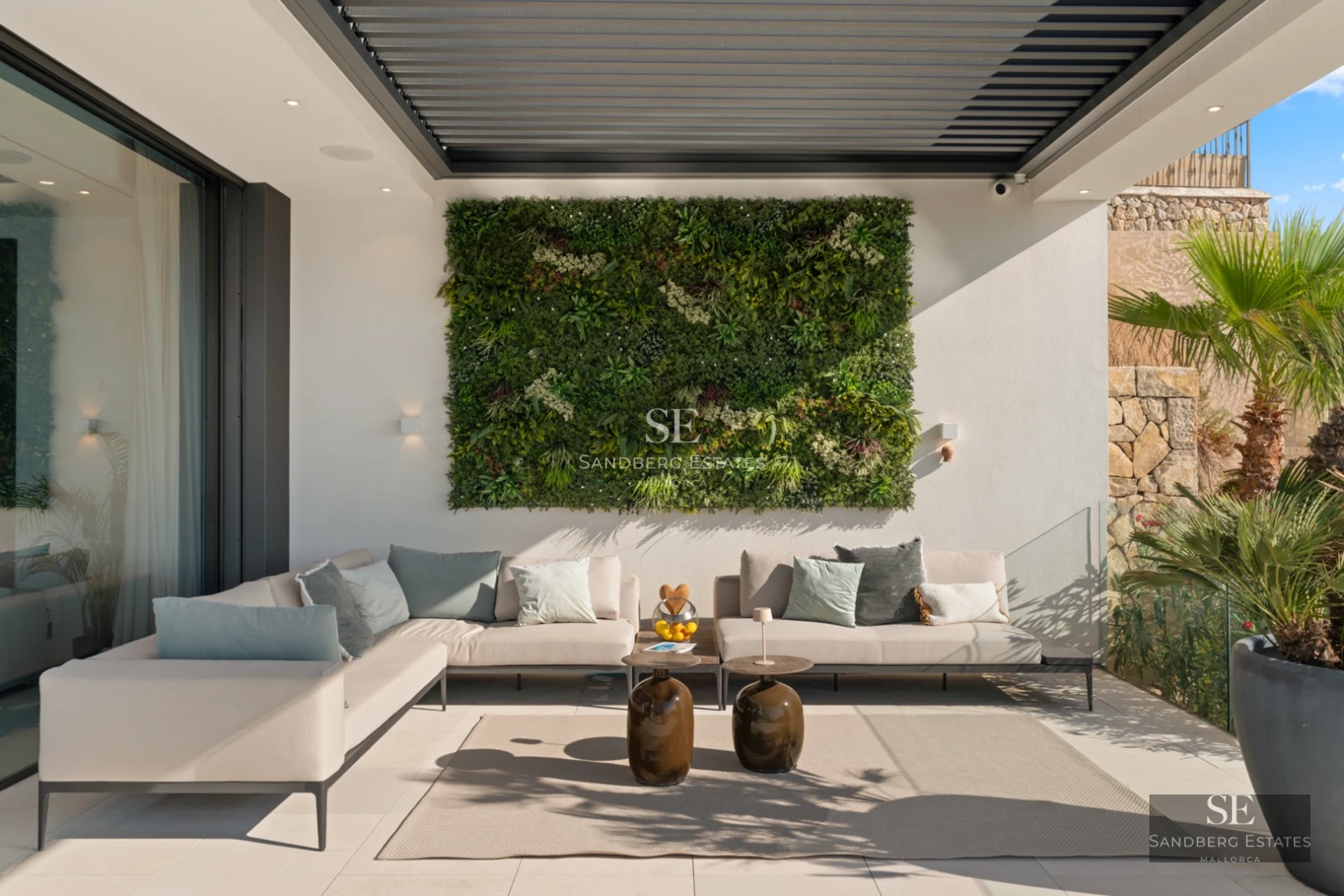 Spacious balcony with panoramic sea views. Modern design featuring glass railings and elegant furniture. Solarium with pool and sun loungers.