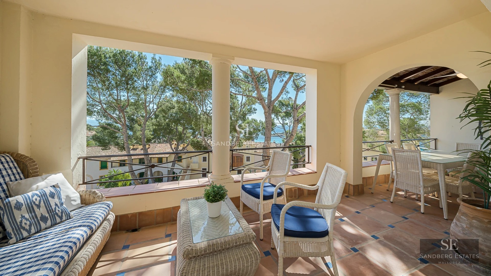 View of a luxurious villa with infinity pool. Modern architecture, large windows, turquoise pool, and lush gardens.
