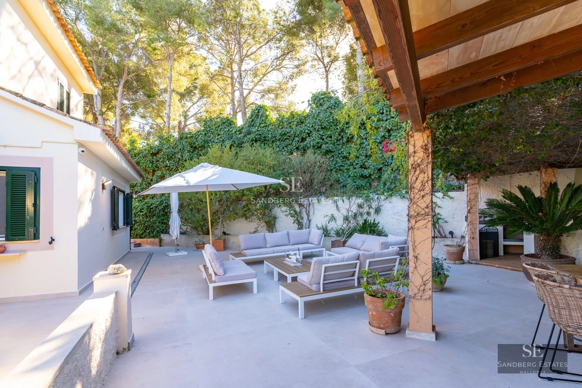 Spacious terrace with infinity pool, sun loungers, and panoramic views. Modern design, high-end finishes, and lush vegetation.