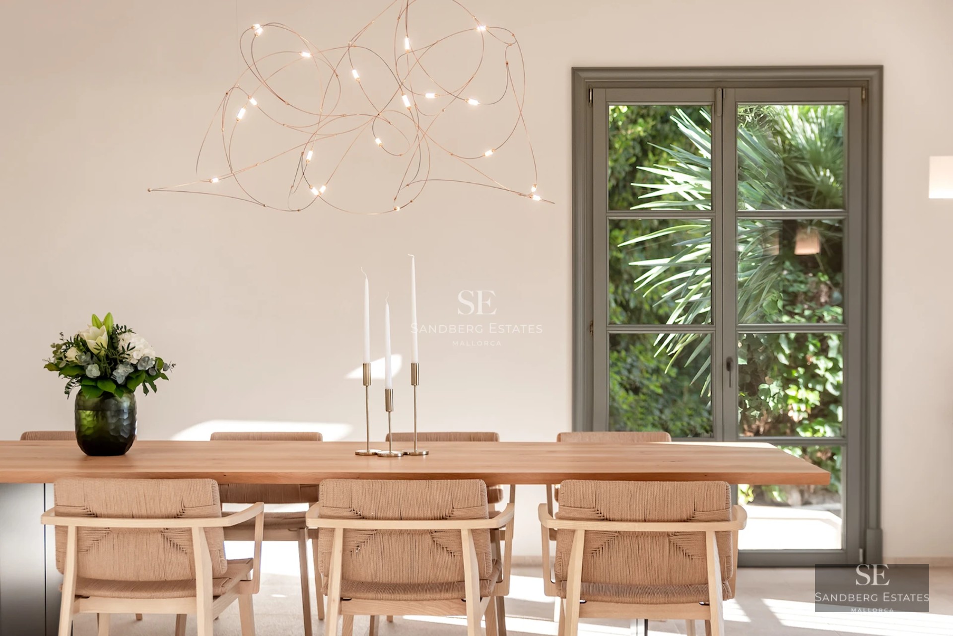 Spacious living room with floor-to-ceiling sea view windows. Modern design, light wood floors, minimalist furniture, and abundant natural light.