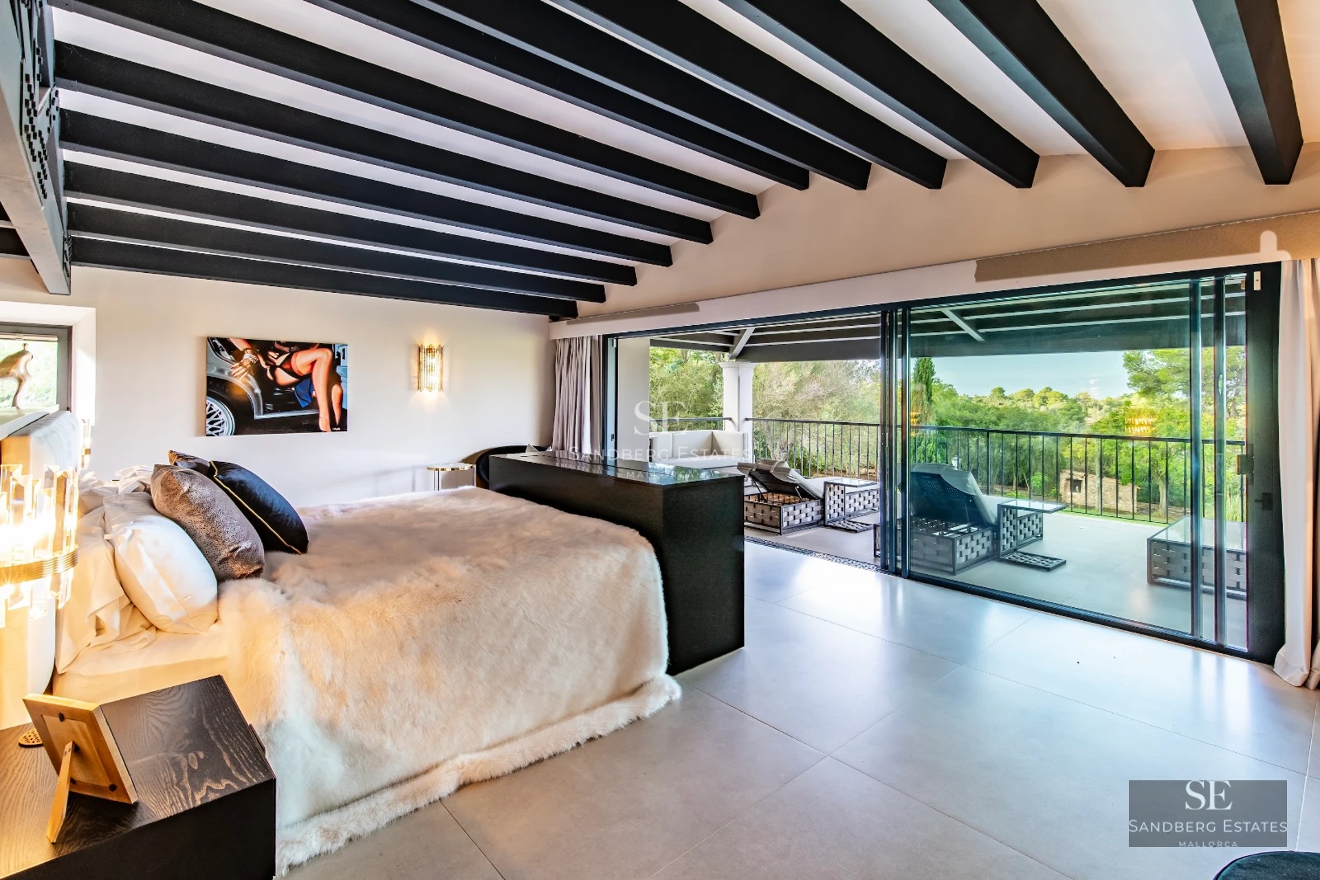 Spacious, bright living room with large windows, modern fireplace, light wood floors, and minimalist decor. Open space with garden views.