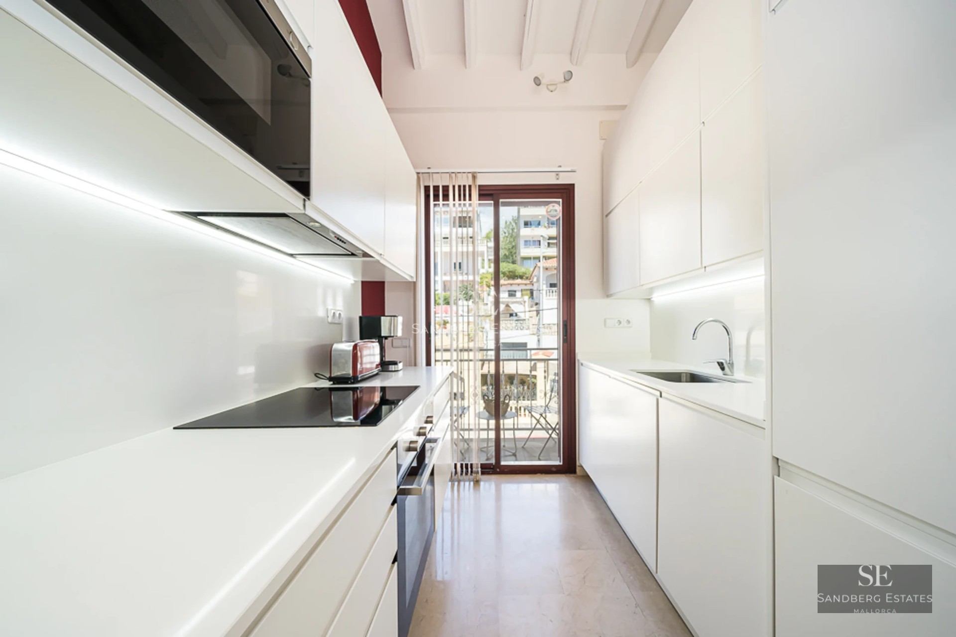 Exterior view of a modern house with an infinity pool, lush garden, and minimalist natural stone facade. Warm lighting.