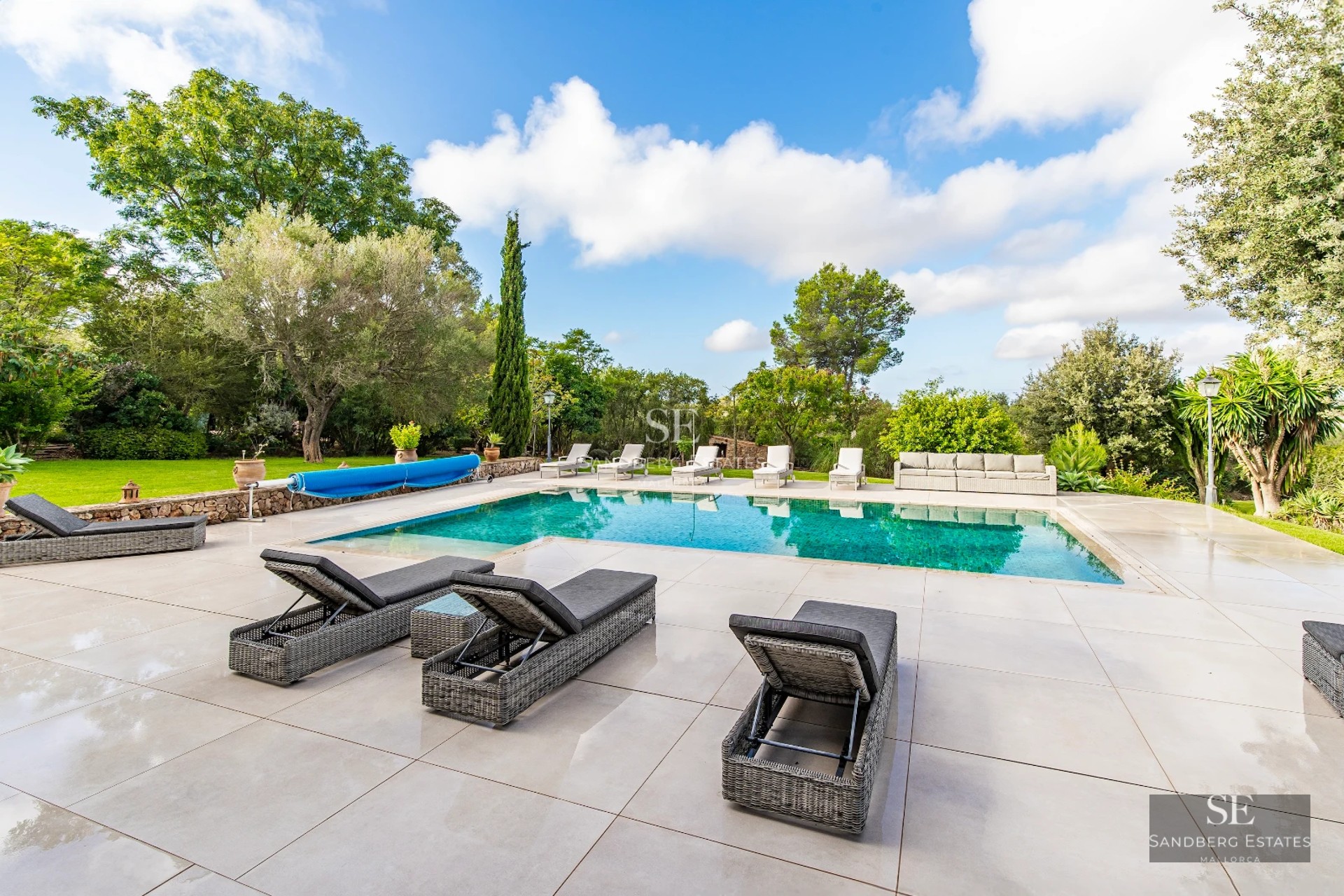 Spacious terrace with infinity pool. Panoramic views. Glass railing. Modern outdoor furniture. Ambient lighting.