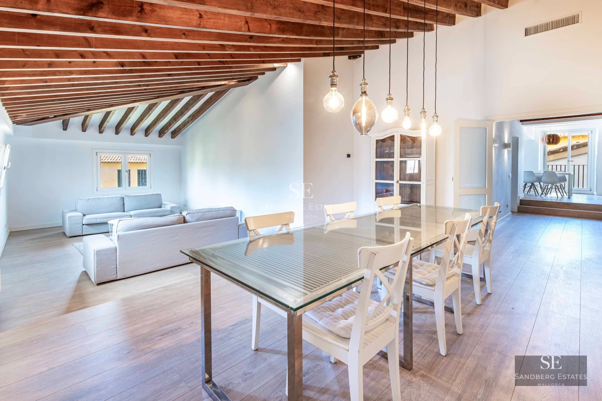 Property view with illuminated pool at sunset. Modern architecture, expansive terraces and lush vegetation. Luxury and comfort.