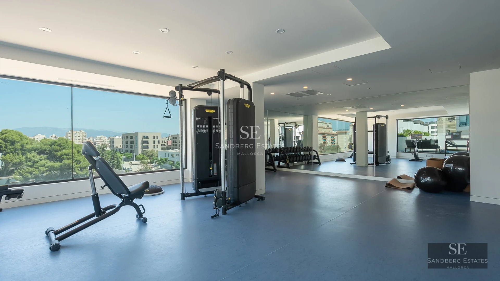 Spacious living room with panoramic sea view windows. Modern design, light wood floors, leather sofas, and designer coffee table.