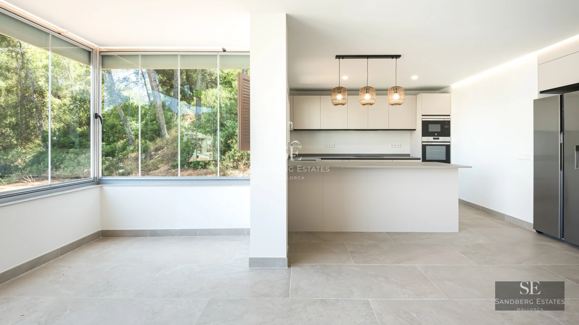 Spacious, bright living room with floor-to-ceiling windows, light wood floors, modern furniture & balcony access with view. Minimalist design.