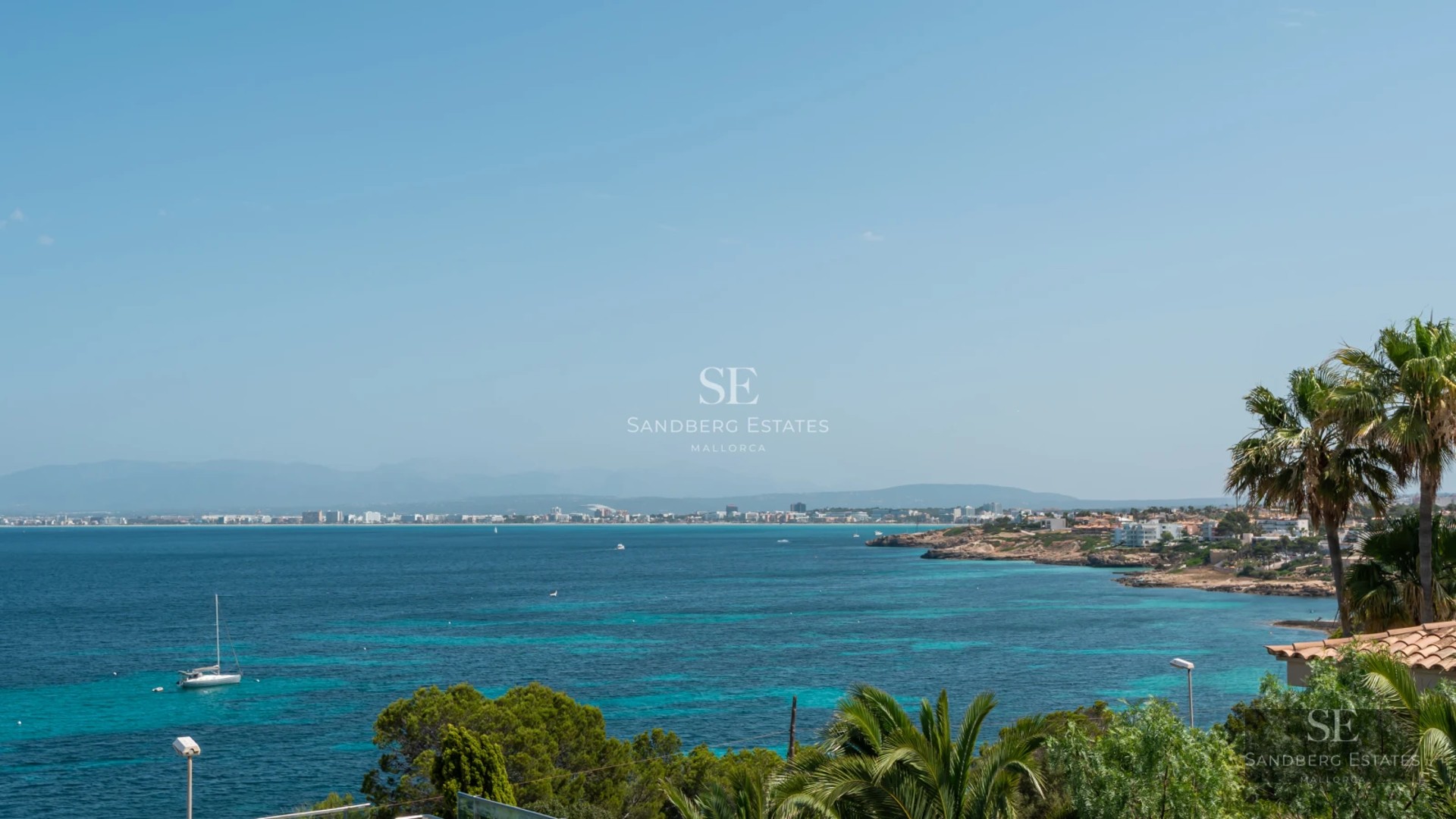 Aerial view of a modern villa featuring a turquoise pool, manicured gardens, and minimalist architecture. Natural lighting.