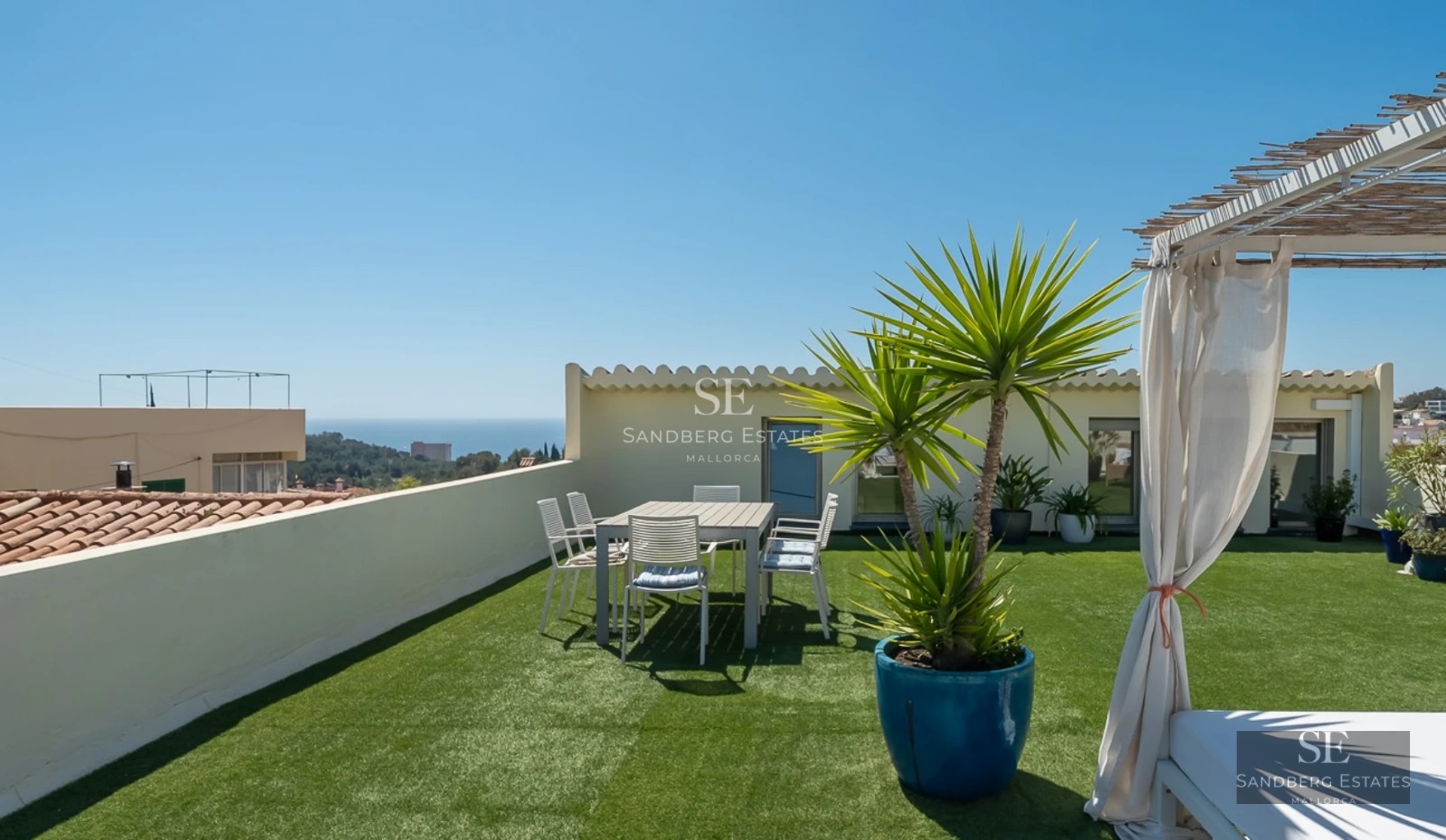 View of luxury modern villa with infinity pool, garden, and large windows. Minimalist design with neutral tones and abundant natural light.