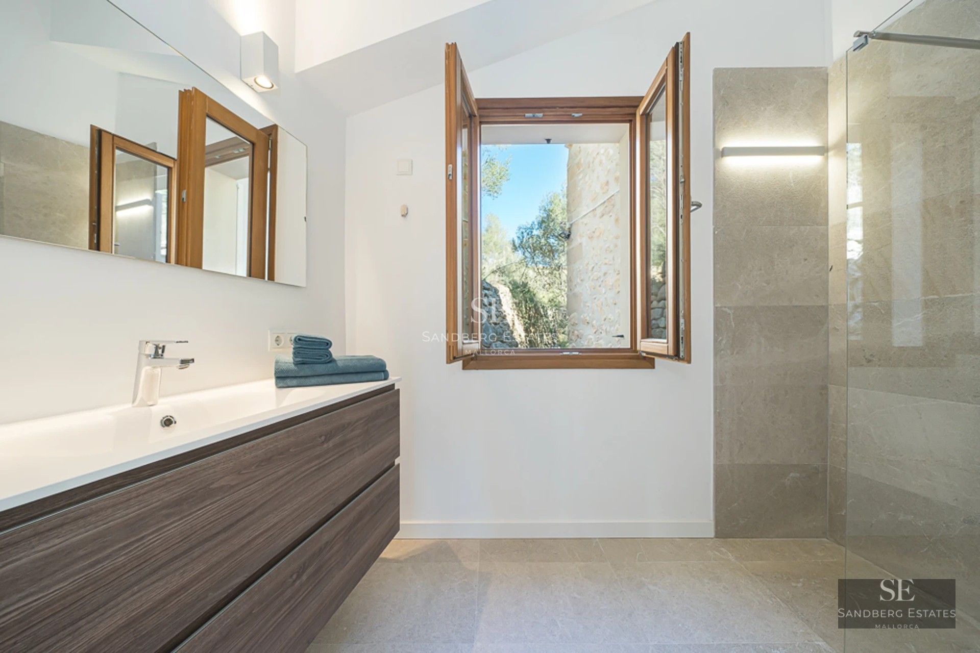 Expansive terrace with infinity pool, sun loungers, and panoramic views. Modern design with wood flooring and glass railing.