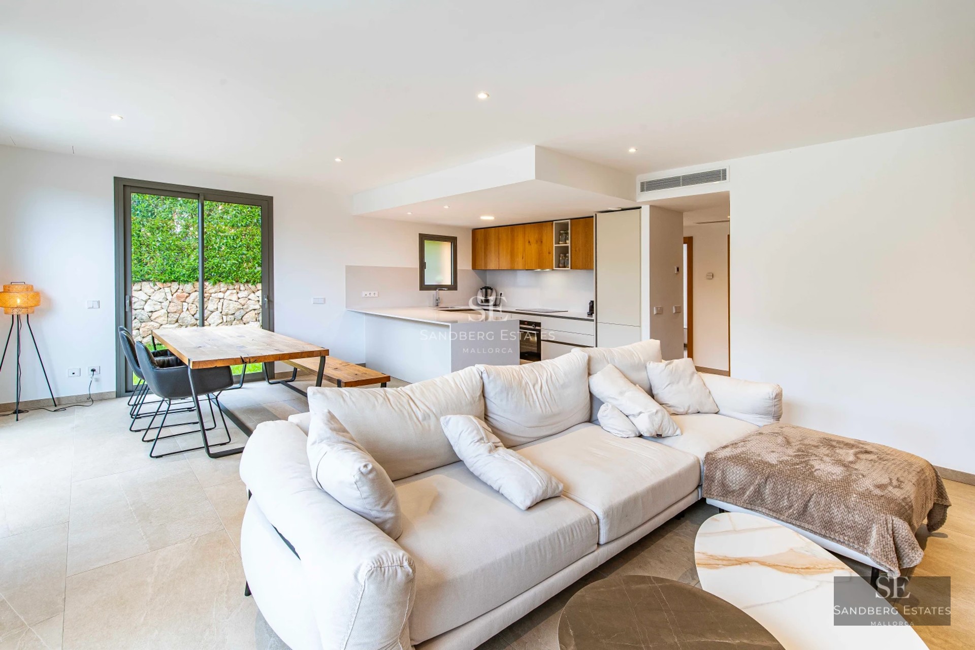 Exterior view of a modern villa with a pool, lush garden, and large terraces. Contemporary architecture with clean lines and large windows.