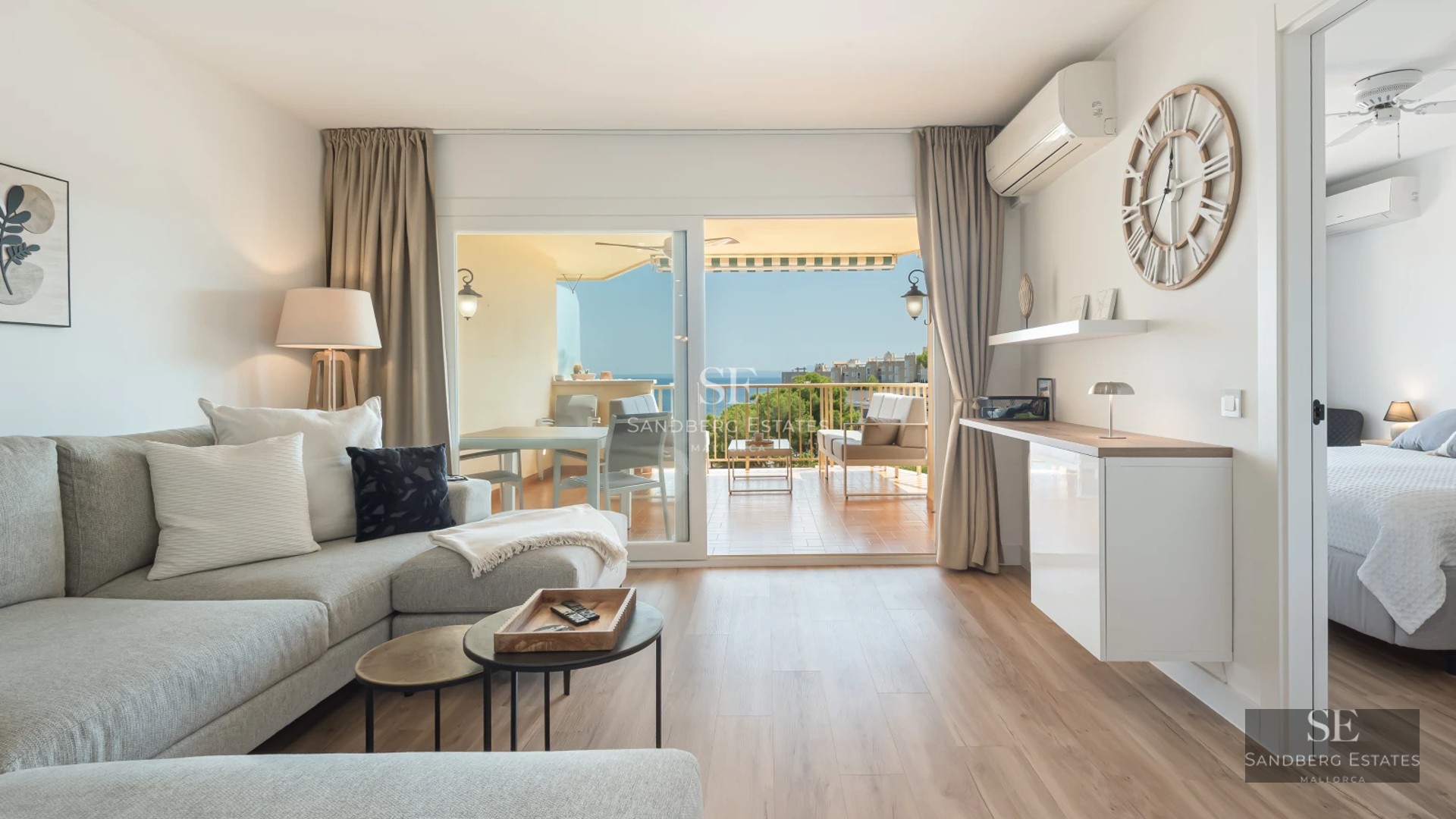 Spacious living room with windows, reflecting pool and modern design. Elegant finishes and abundant natural light. Sophisticated and relaxing space.